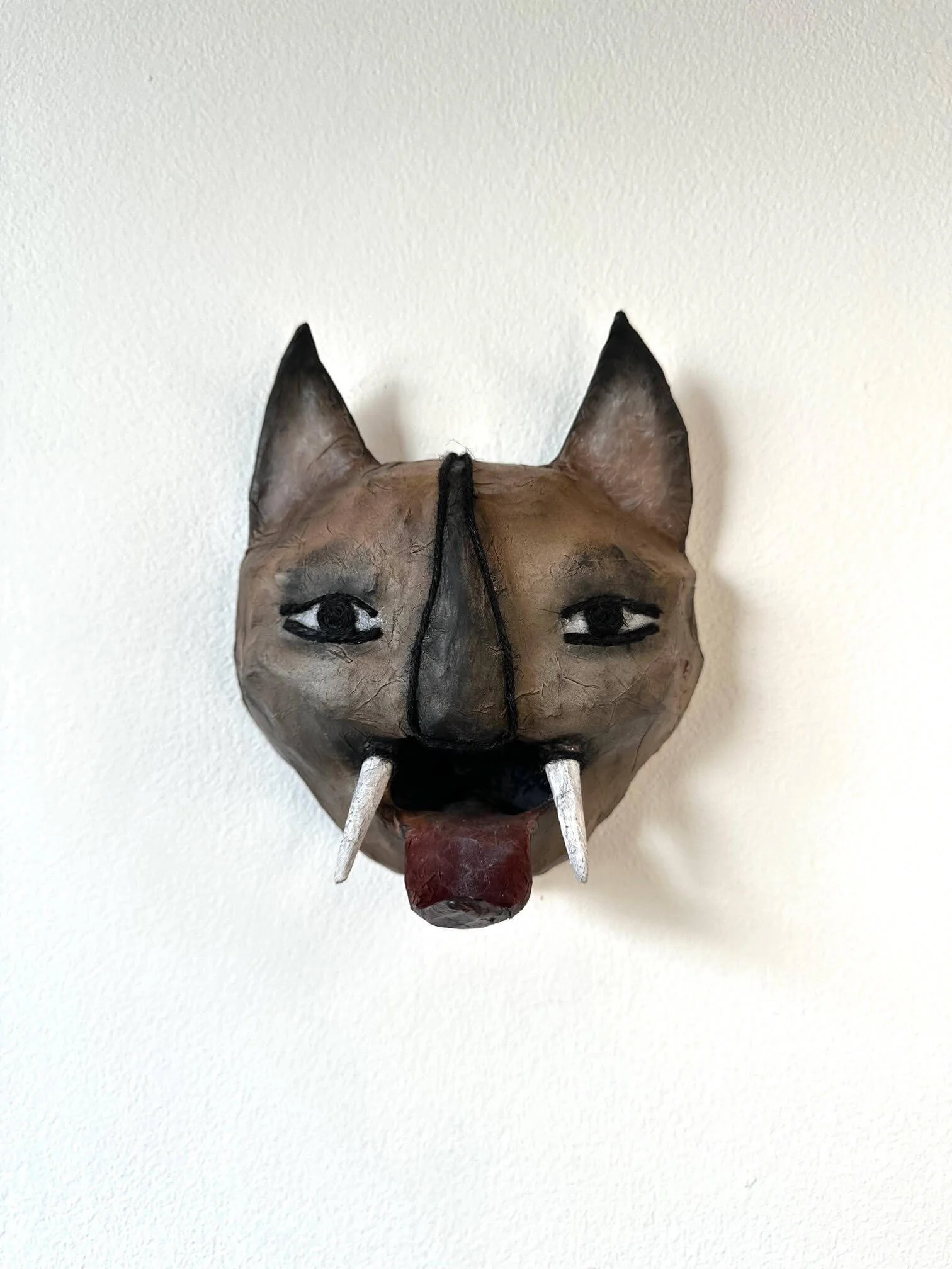 Instinct animal mask sculpture made from reclaimed cardboard and paper viewed from the front