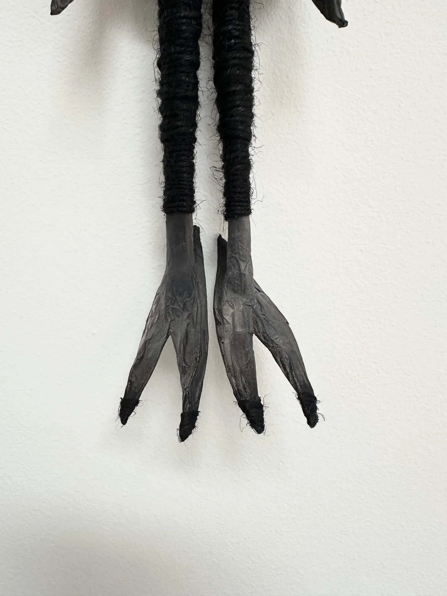 Crow Creature, eco-conscious paper sculpture showing close-up of feet details