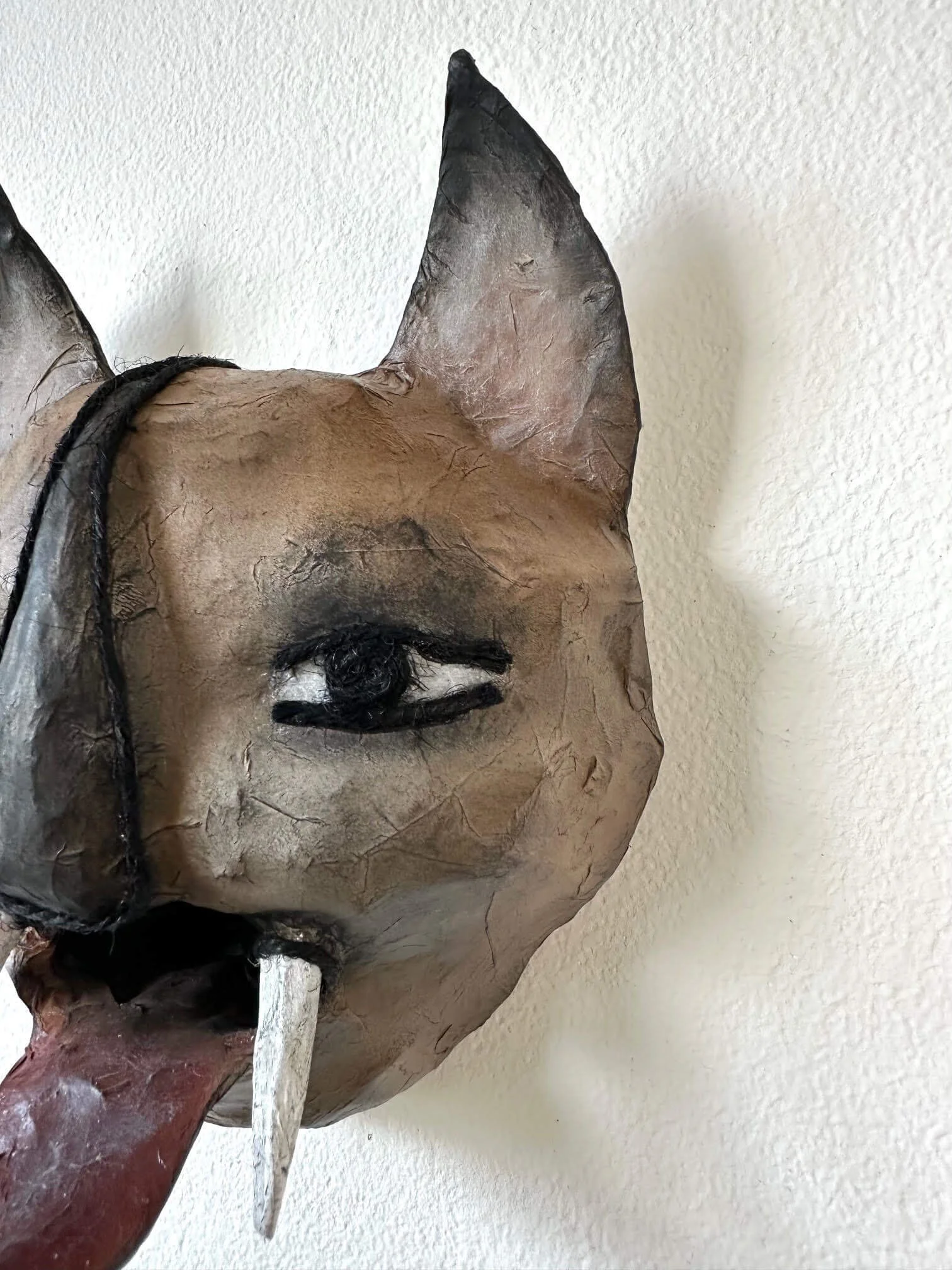 Instinct sculpture close-up of details of mask, made from cardboard and paper