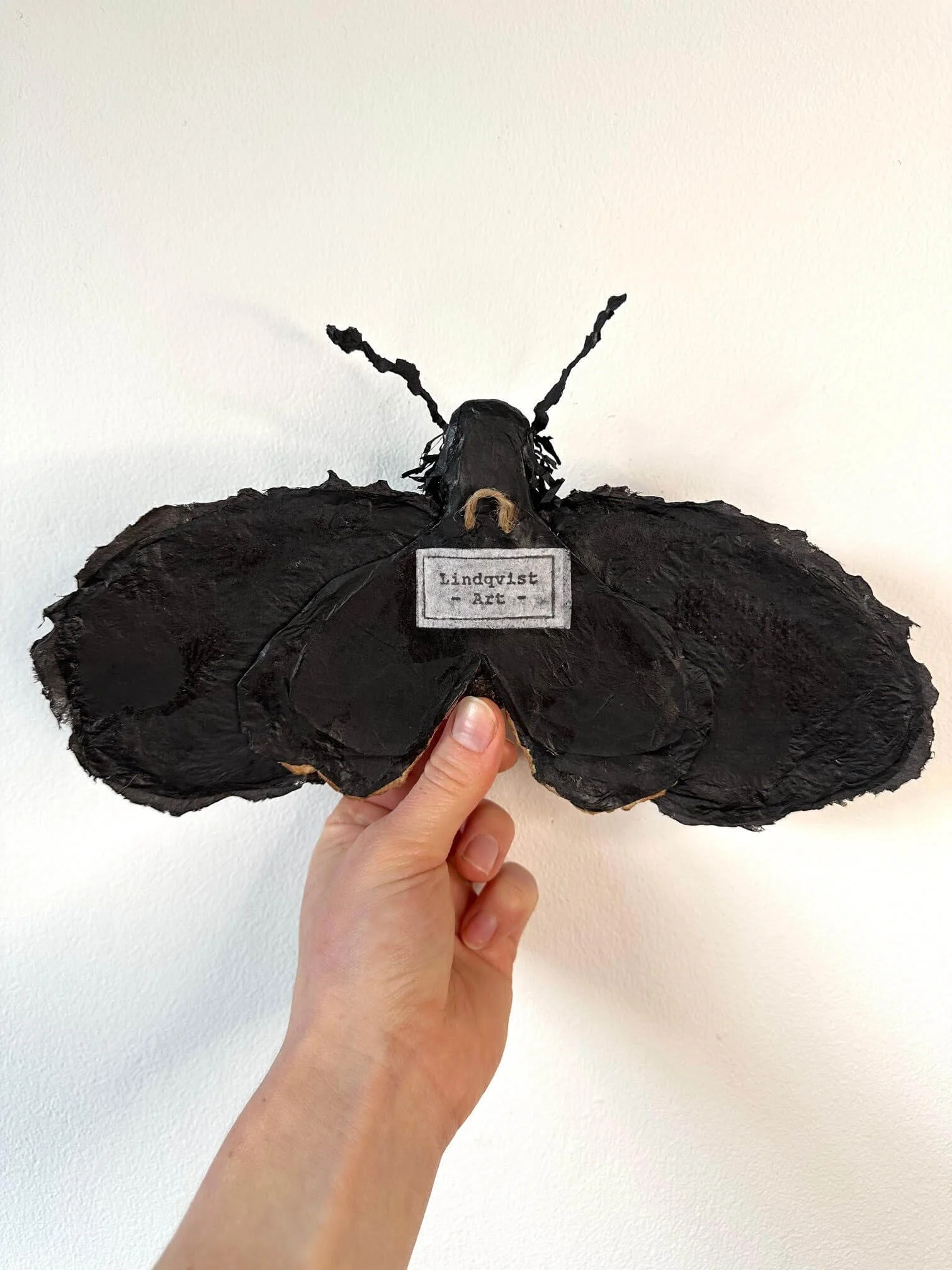 View of backside of Moth wall sculpture with Lindqvist Art stamp and hanging loop, made by Lindqvist Art