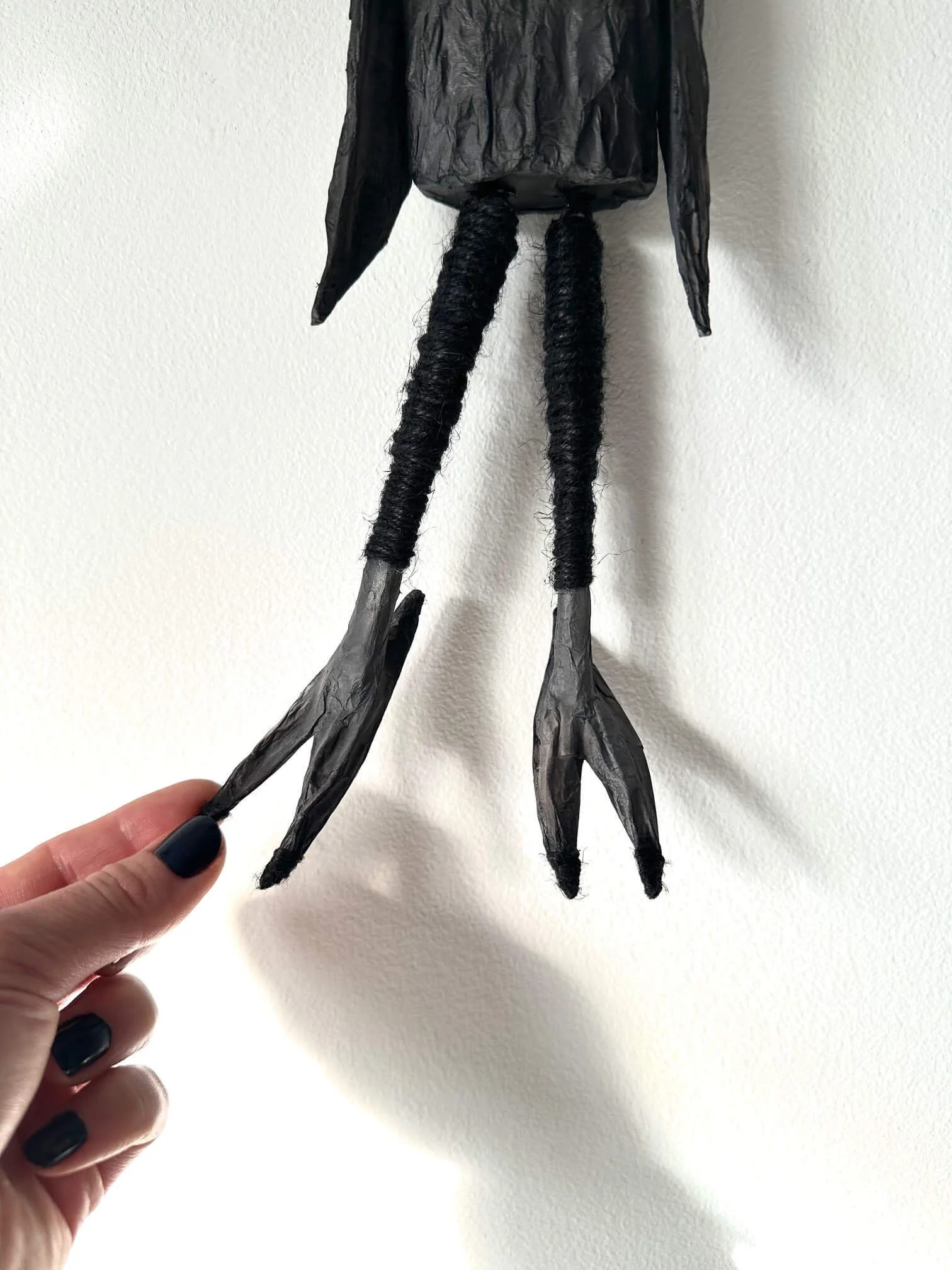 Crow Creature, cardboard and paper sculpture showing moving leg detail