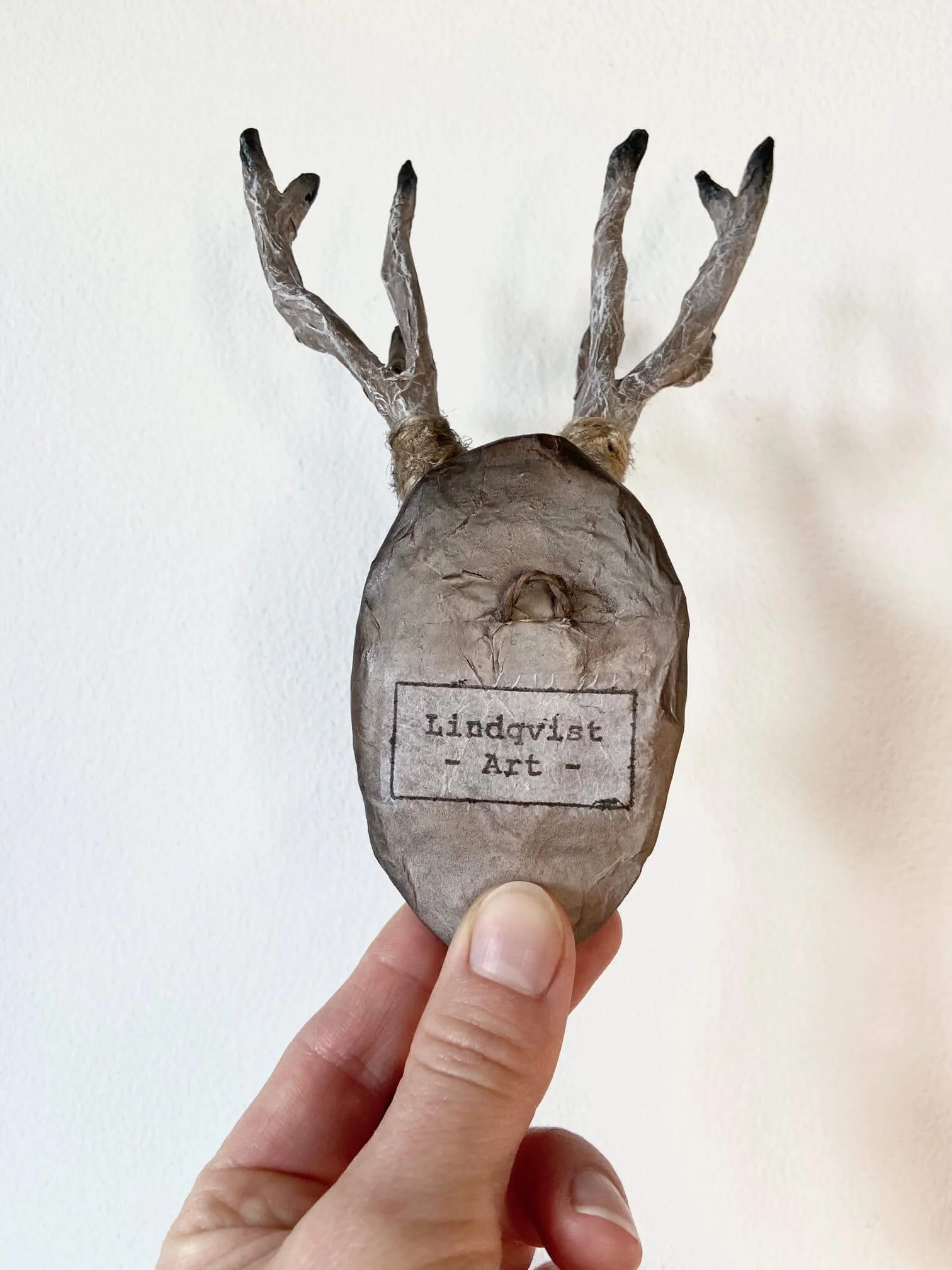 Trust deer head cardboard and paper sculpture with Lindqvist Art stamp on the back