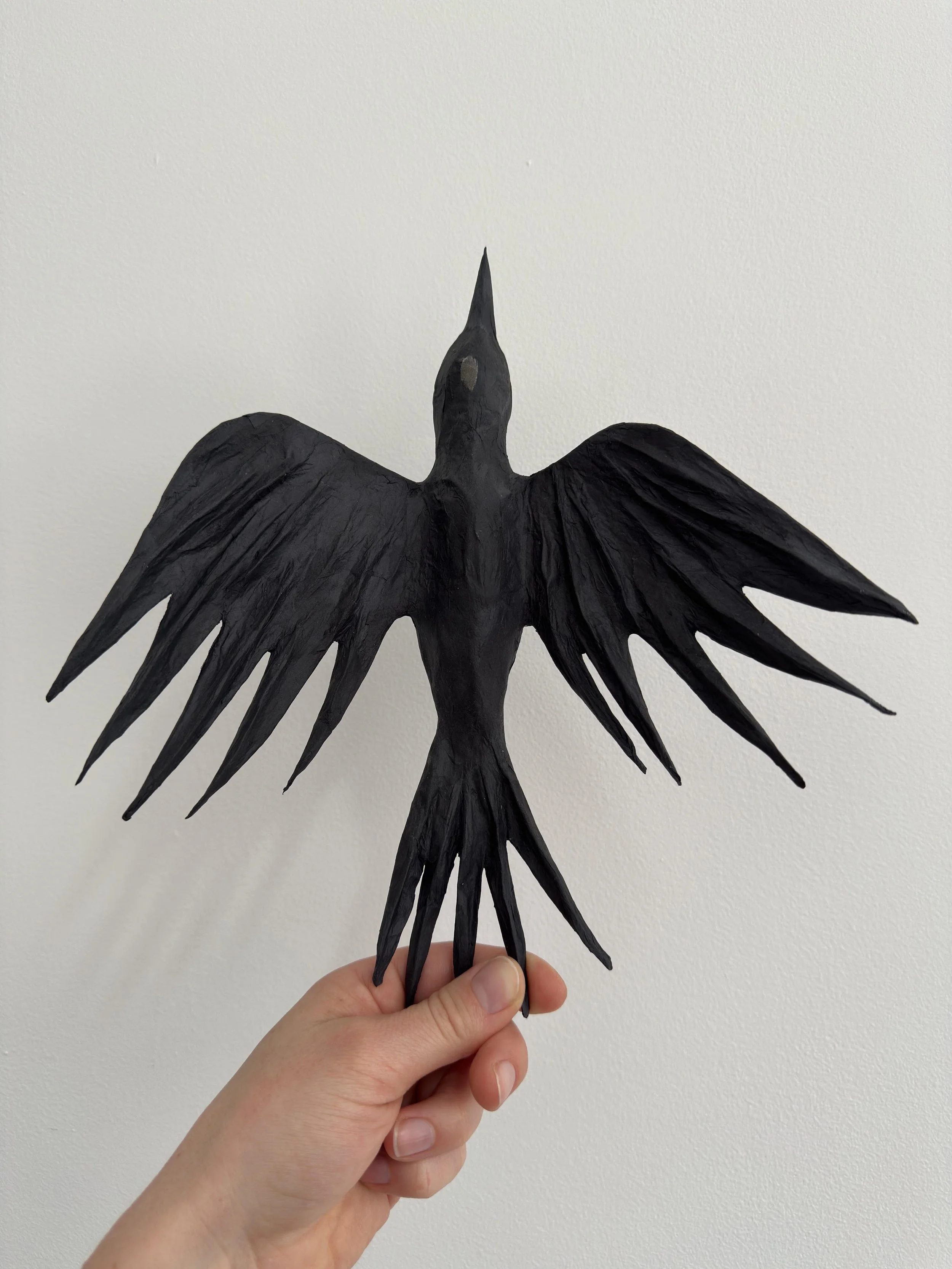 Original bird sculpture held in hand, by eco-conscious artist Caroline Lindqvist