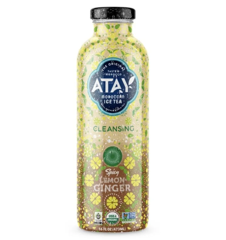 Bottle of Atay Moroccan Ice Tea in Spicy Lemon Ginger flavor, featuring a colorful floral design with 16 oz capacity. USDA Organic and Non-GMO logos visible.