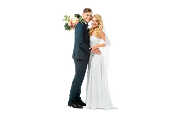 Bride and groom posing together in formal wedding attire