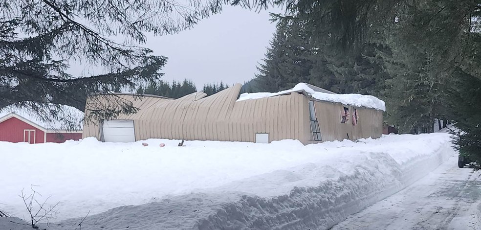 Snow-covered gym building at Echo Ranch Bible Camp in Southeast Alaska after roof collapse caused by record winter storm