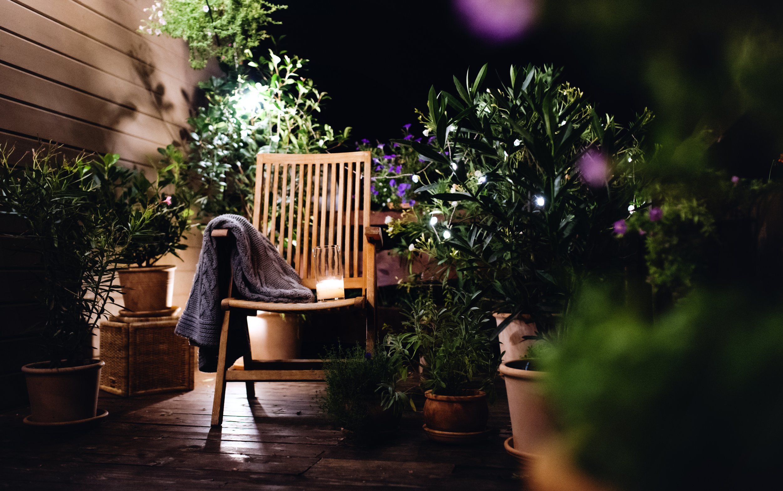light candle-on-chair-in-the-evening-on-terrace-in-summe-2023-11-27-05-34-29-utc.jpg