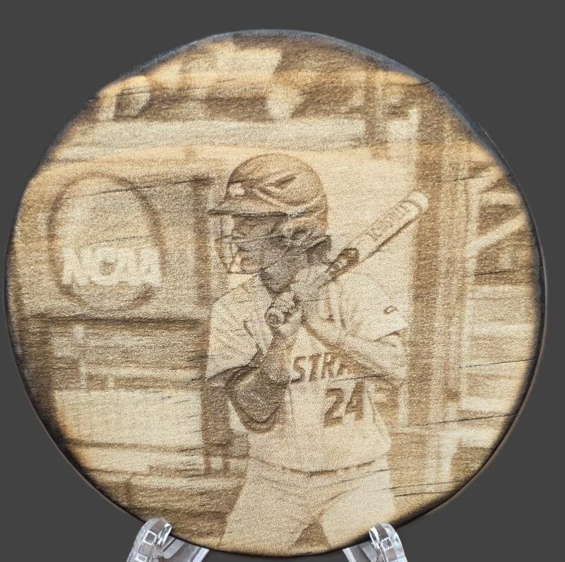 4" Round – Collegiate Softball Engraving
Laser‑engraved on a 4" wooden round, this piece features a collegiate softball player at the plate, complete with helmet and jersey details. A sharp, detailed keepsake that captures the moment with precision.
