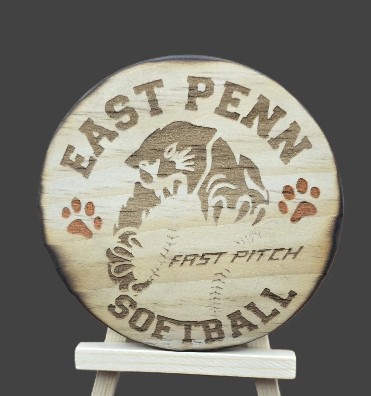 Wooden plaque featuring a baseball theme with a baseball, tiger character, and the words 'Eastern Softball' and 'Fast Pitch' engraved, along with paw prints.