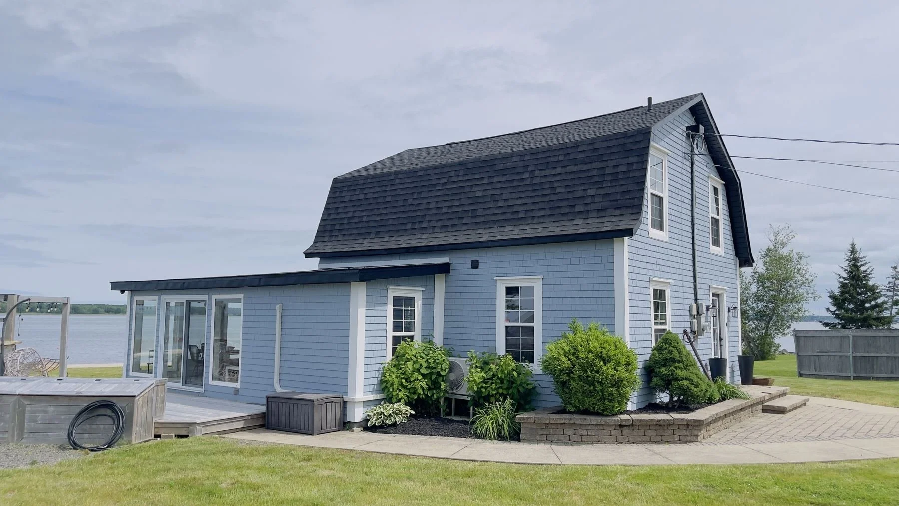 Shingled gambrel house by the water, Shediac