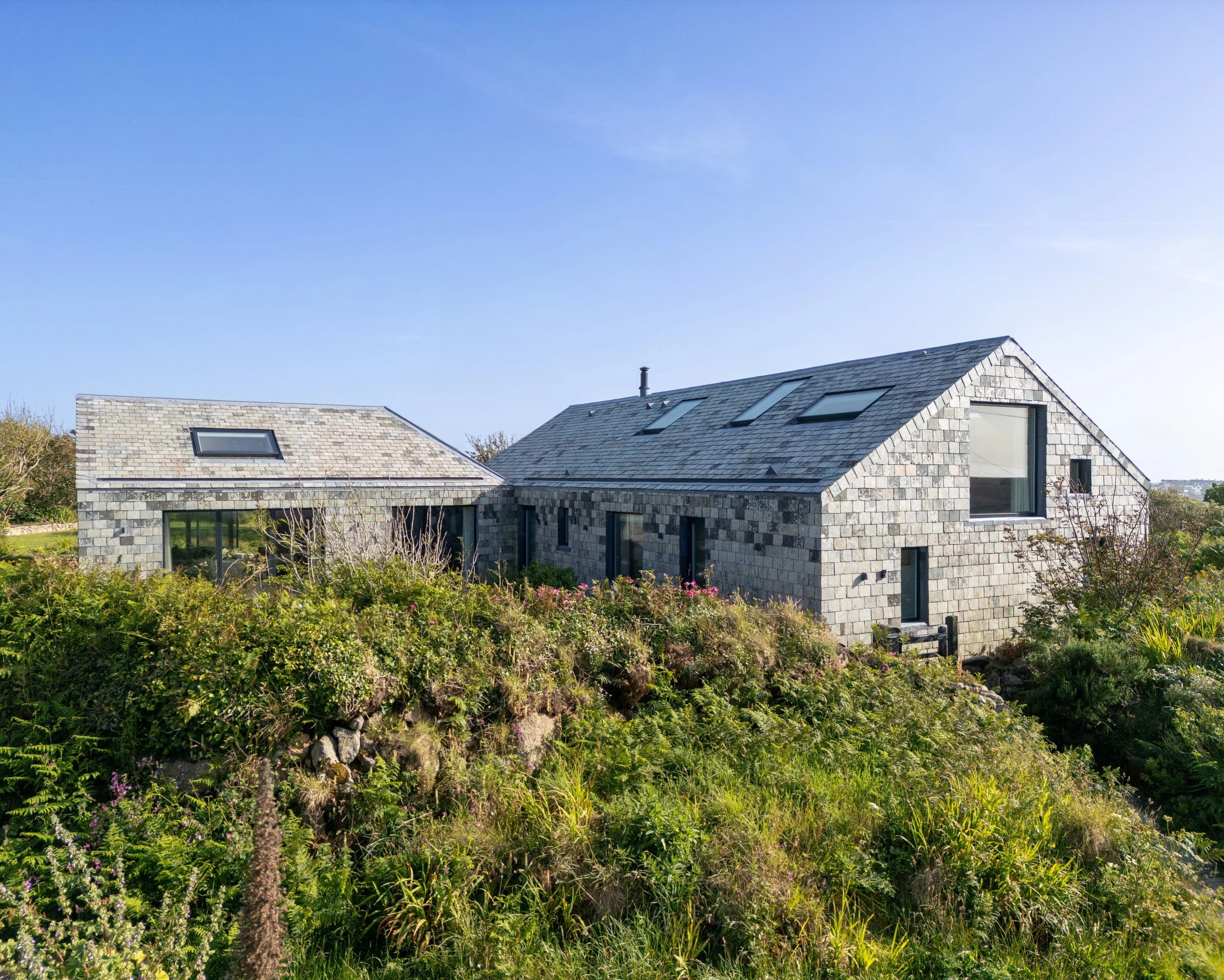  House at the End of the Land 

 

 A quiet haven at the end of the land. 

 

  At the wild western edge of Cornwall, where Atlantic winds shape the landscape and salt hangs in the air, an unassuming mid-century bungalow has been transformed into a 