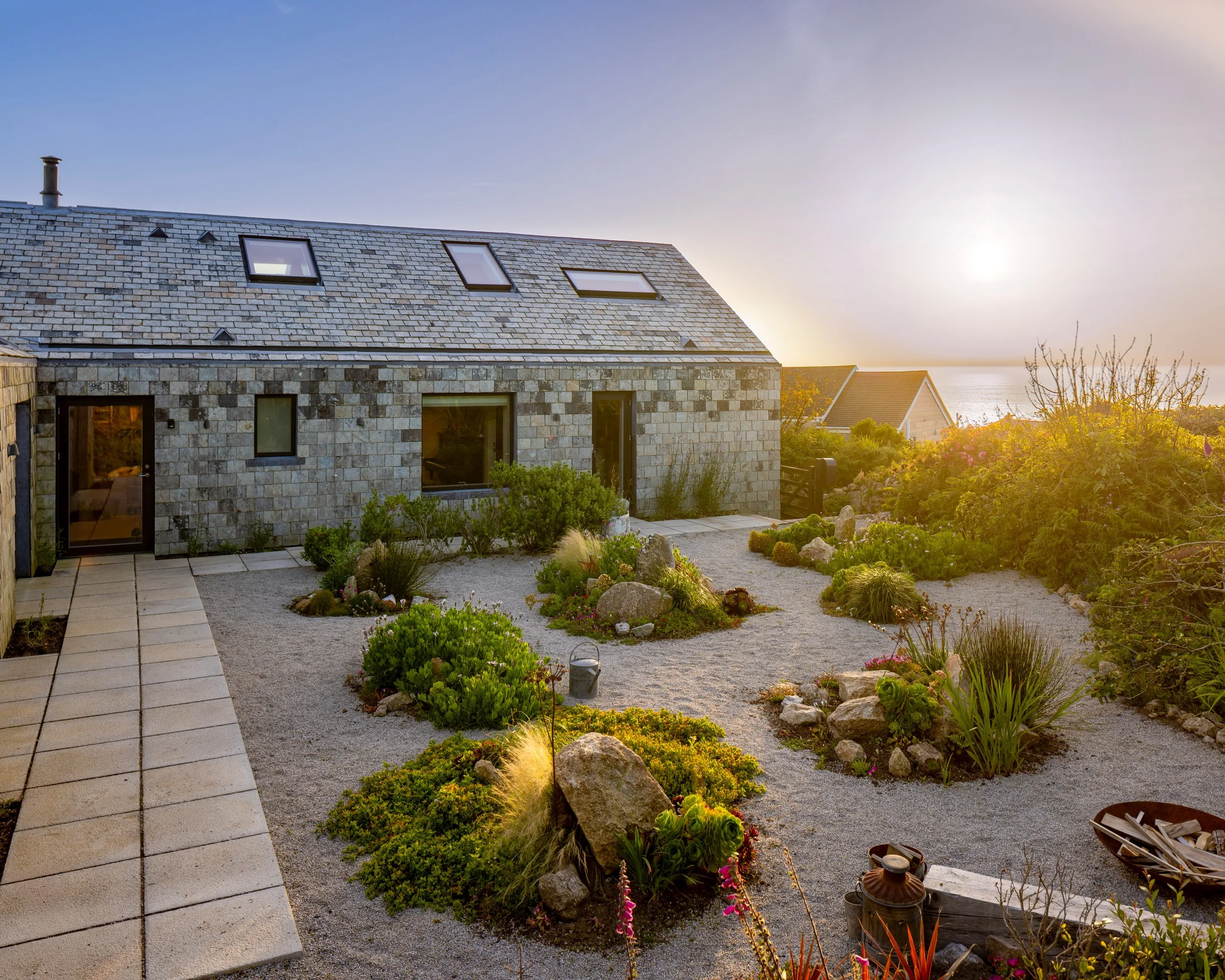   

 

  Arranged as an L-shaped plan around a sheltered courtyard, the house creates a protected world of its own. While the outer elevations withstand the full force of Atlantic weather, the courtyard becomes a calm garden where light, planting and
