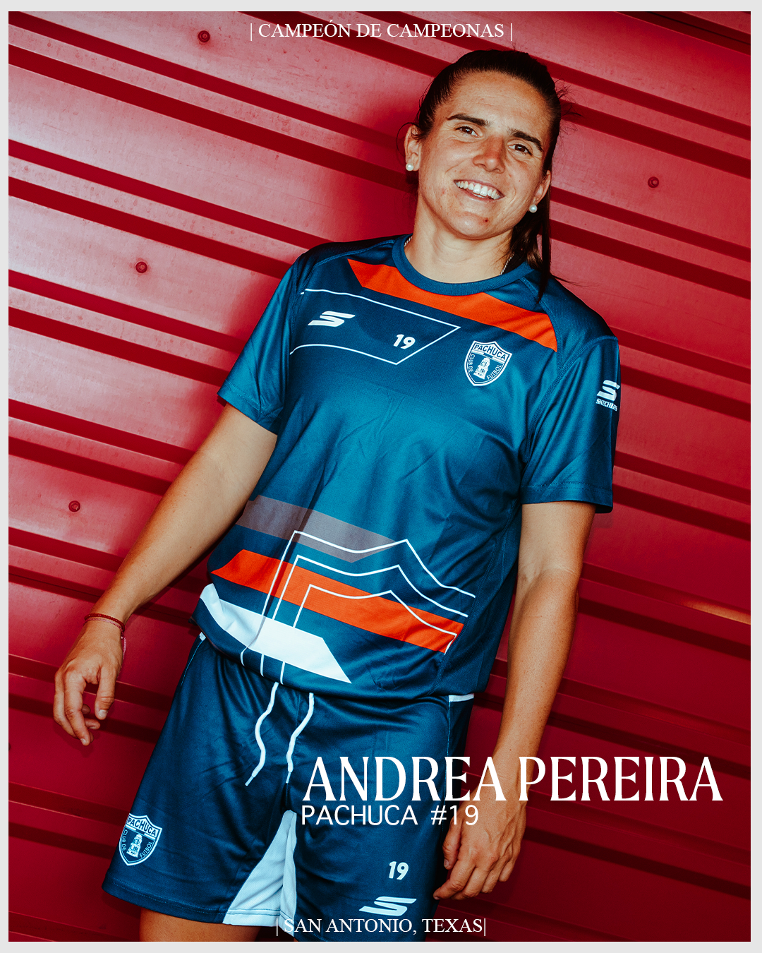 Portrait of Andrea Pereira wearing a blue Pachuca soccer jersey and shorts, standing against a red horizontal slat wall. The image features her smiling, with text indicating she is a champion from San Antonio, Texas, with the number 19.