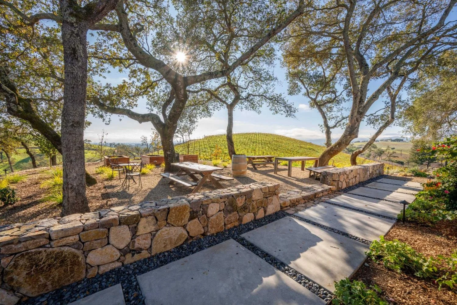 Landscape design with natural stone walls and built-in seating in Napa, CA