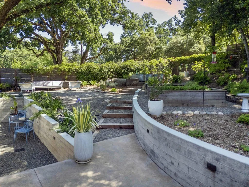 Large concrete patio defining outdoor living zones in Healdsburg, CA