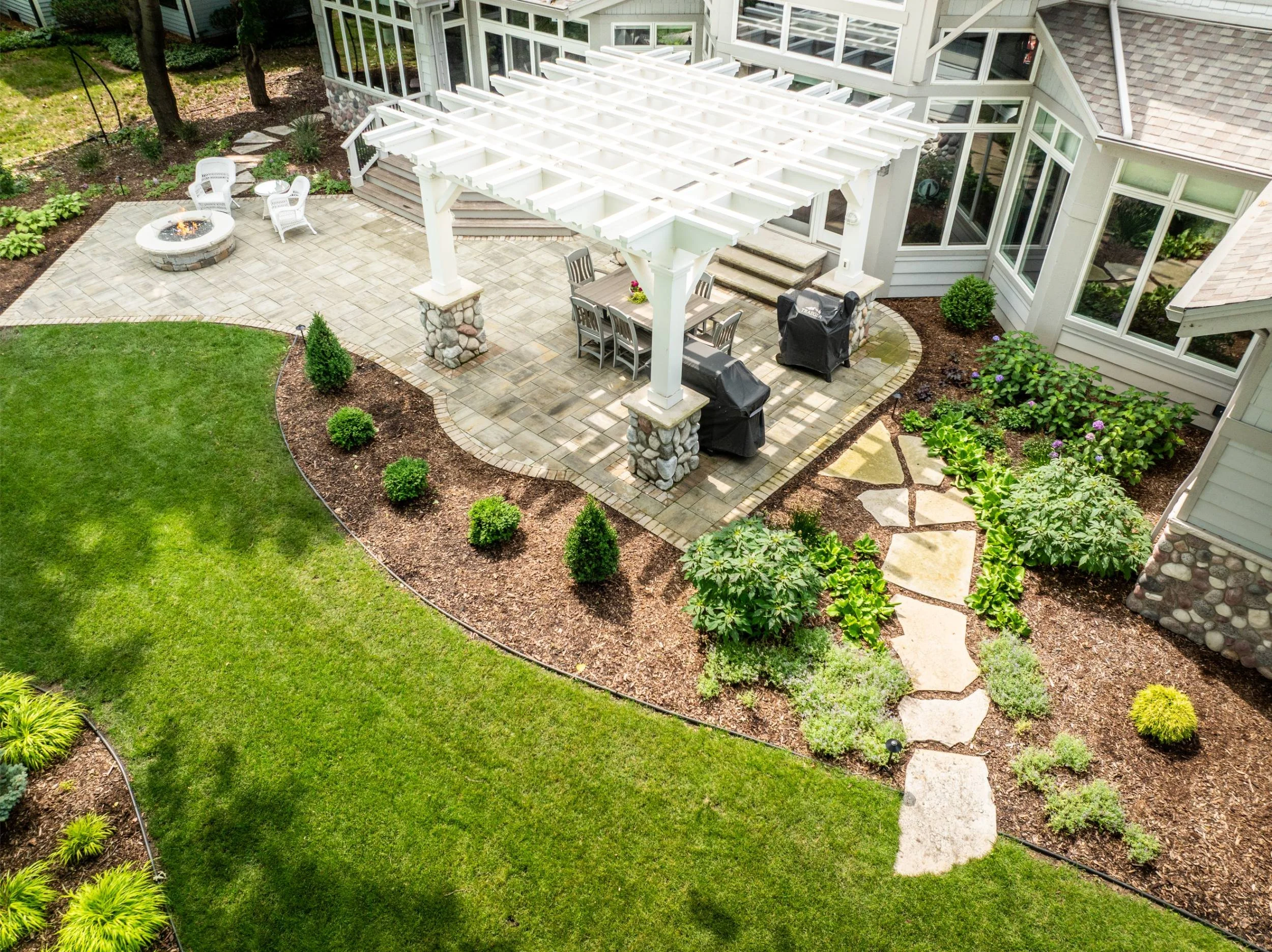A cozy fire pit set among natural stone and greenery in Greenville, WI