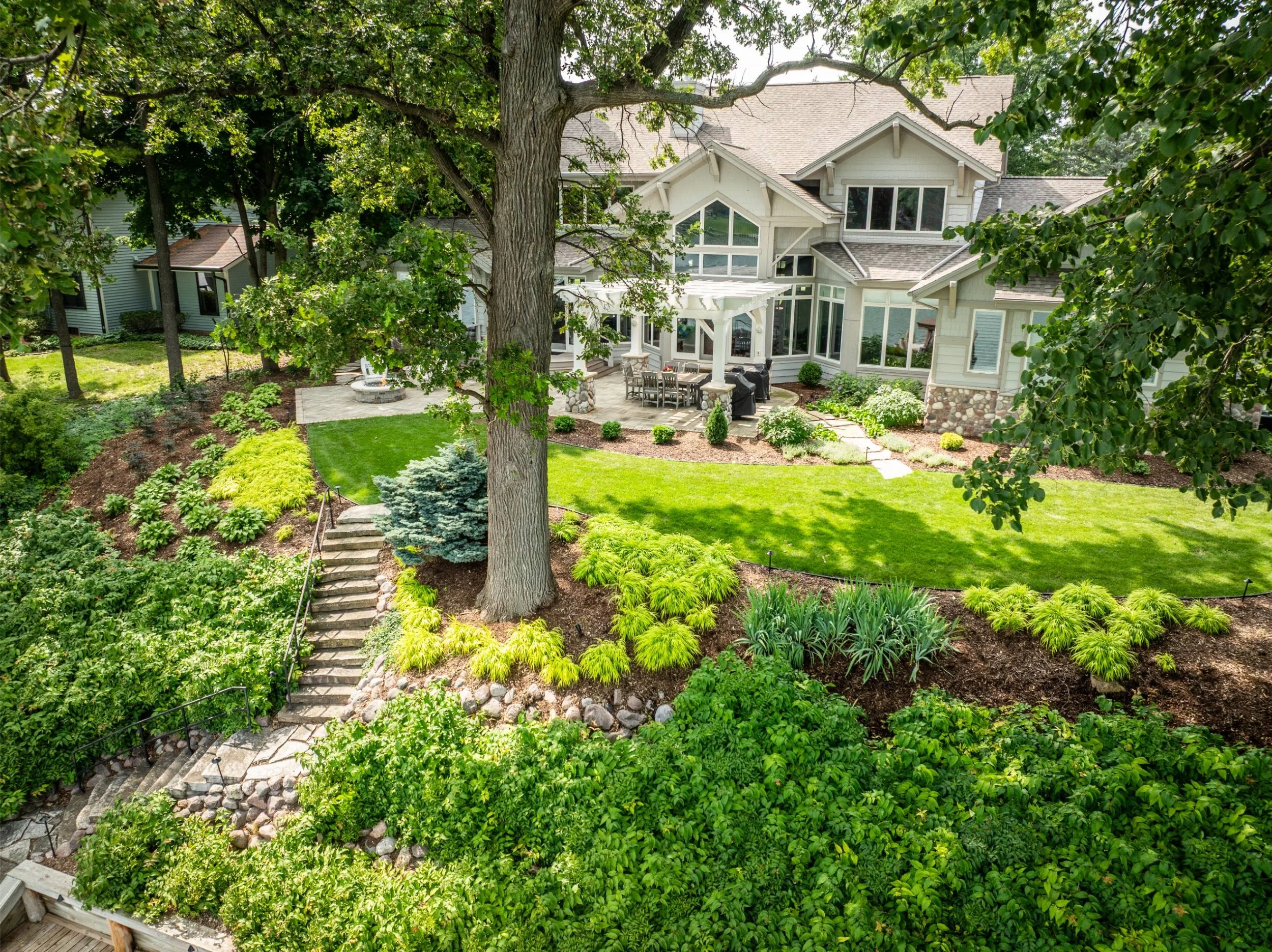 A waterfront backyard cultivated with plants from a garden center in Green Bay, WI