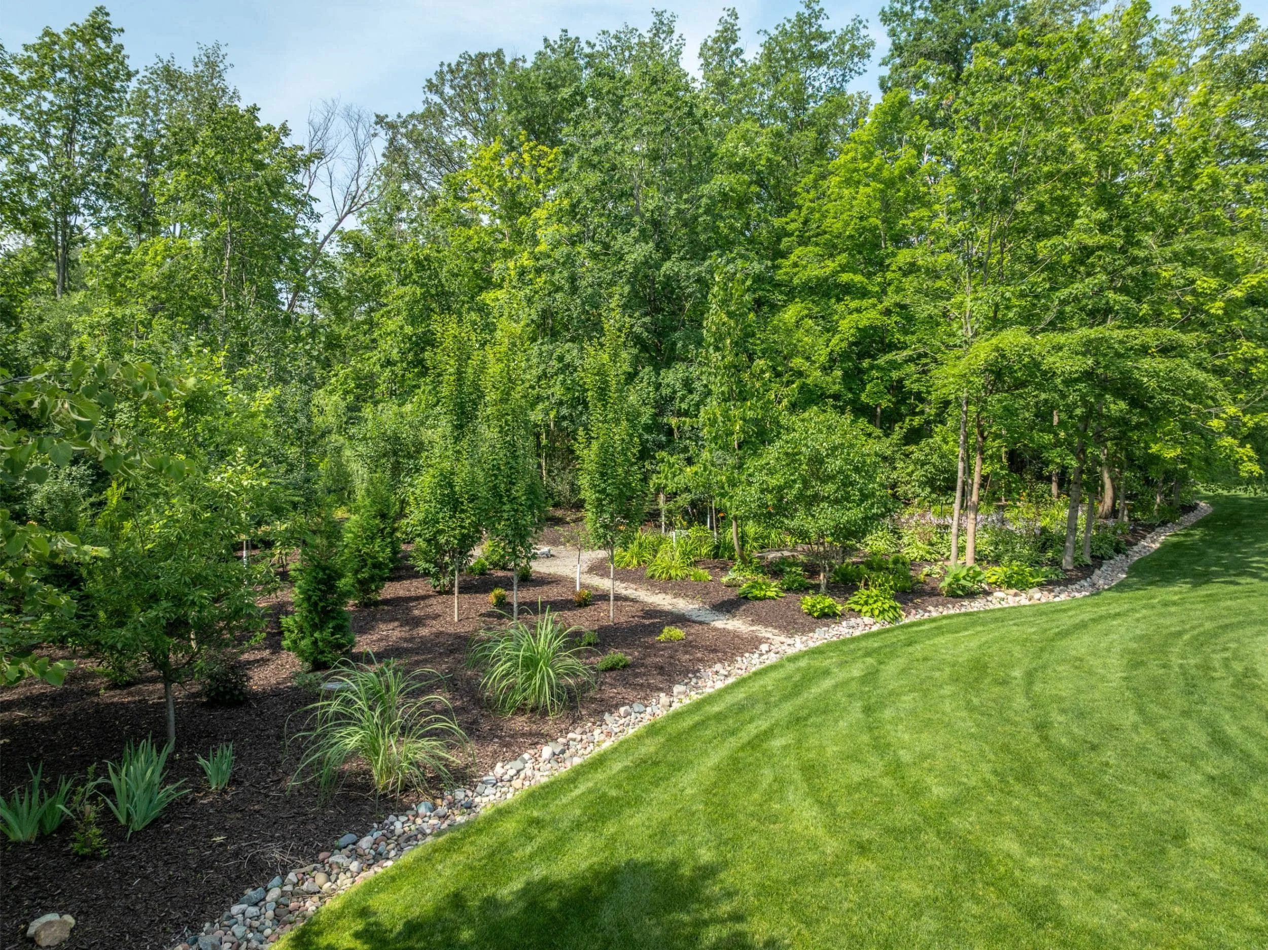 A rustic pergola surrounded by native plants in Oshkosh, WI