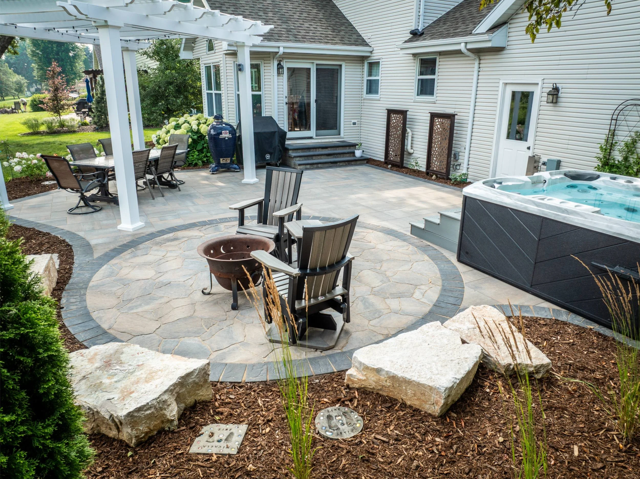 A modern paver patio with vibrant planting design in Green Bay, WI