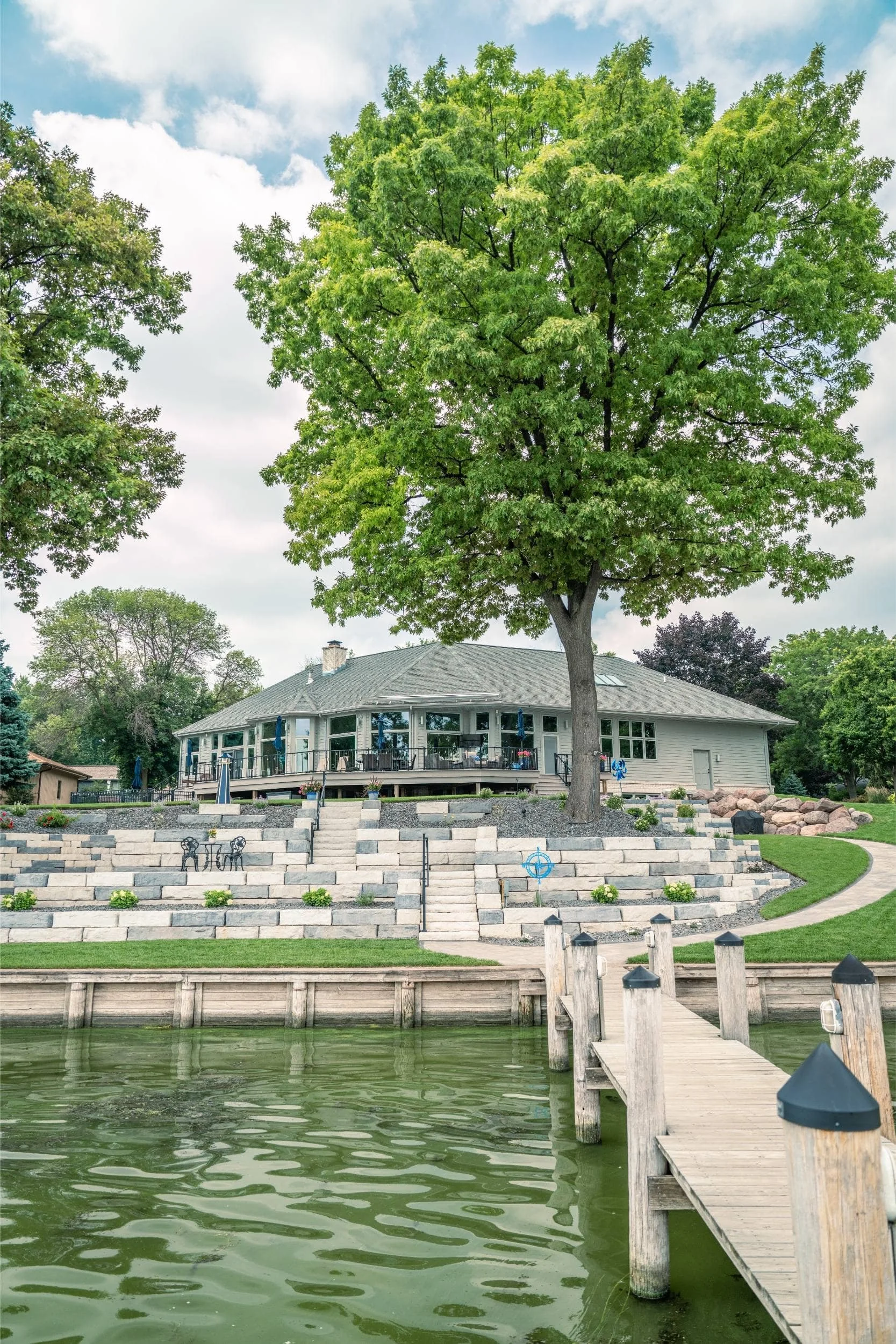 A rustic pergola set among mature trees in the Fox Valley, WI