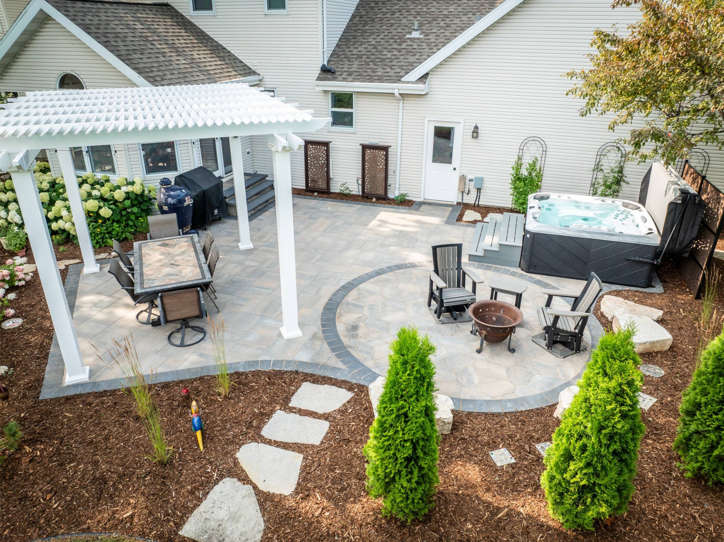 A patio and pergola combination created by a deck builder near me in Appleton, WI