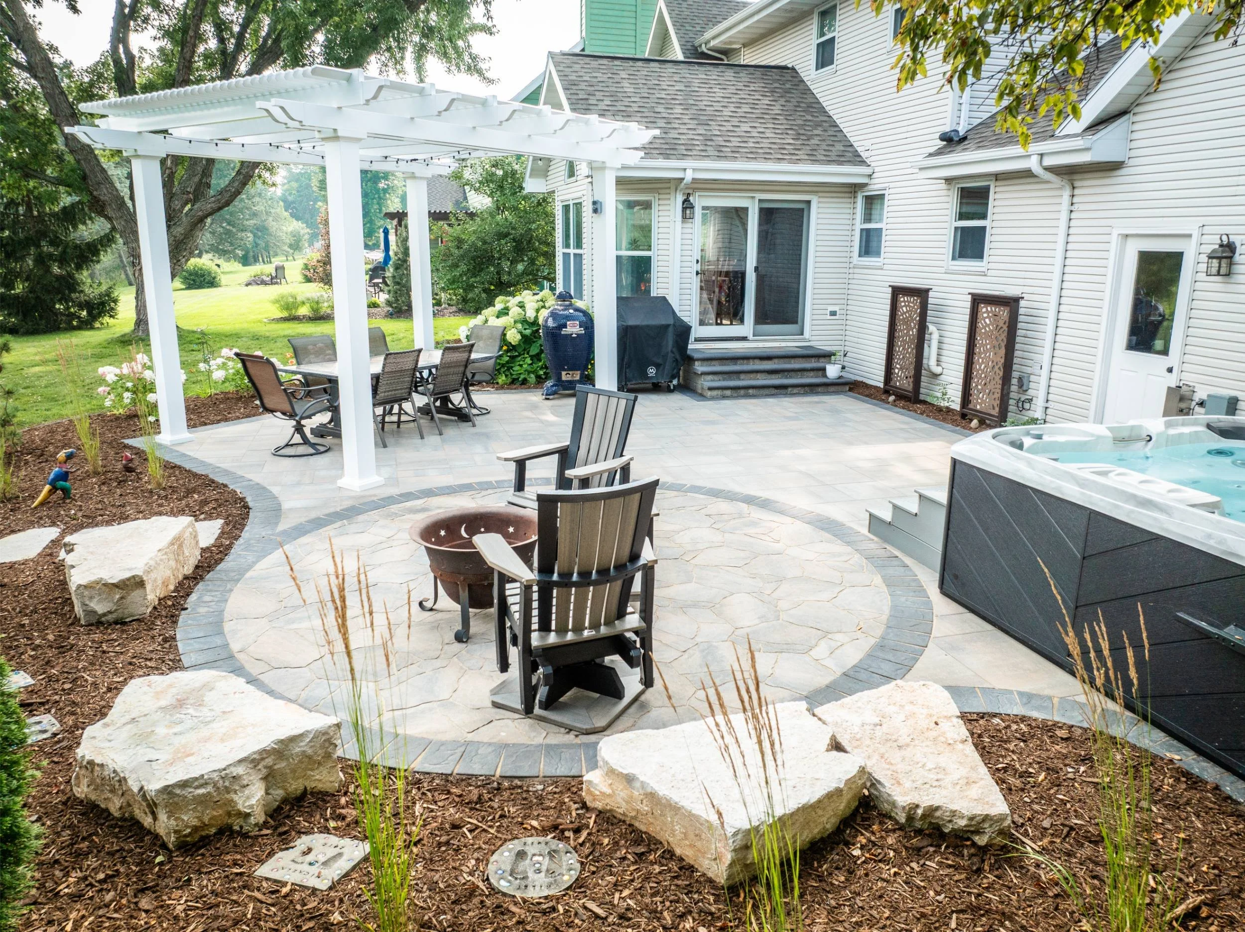 A backyard entertainment space with a fire pit in the Fox Valley, WI