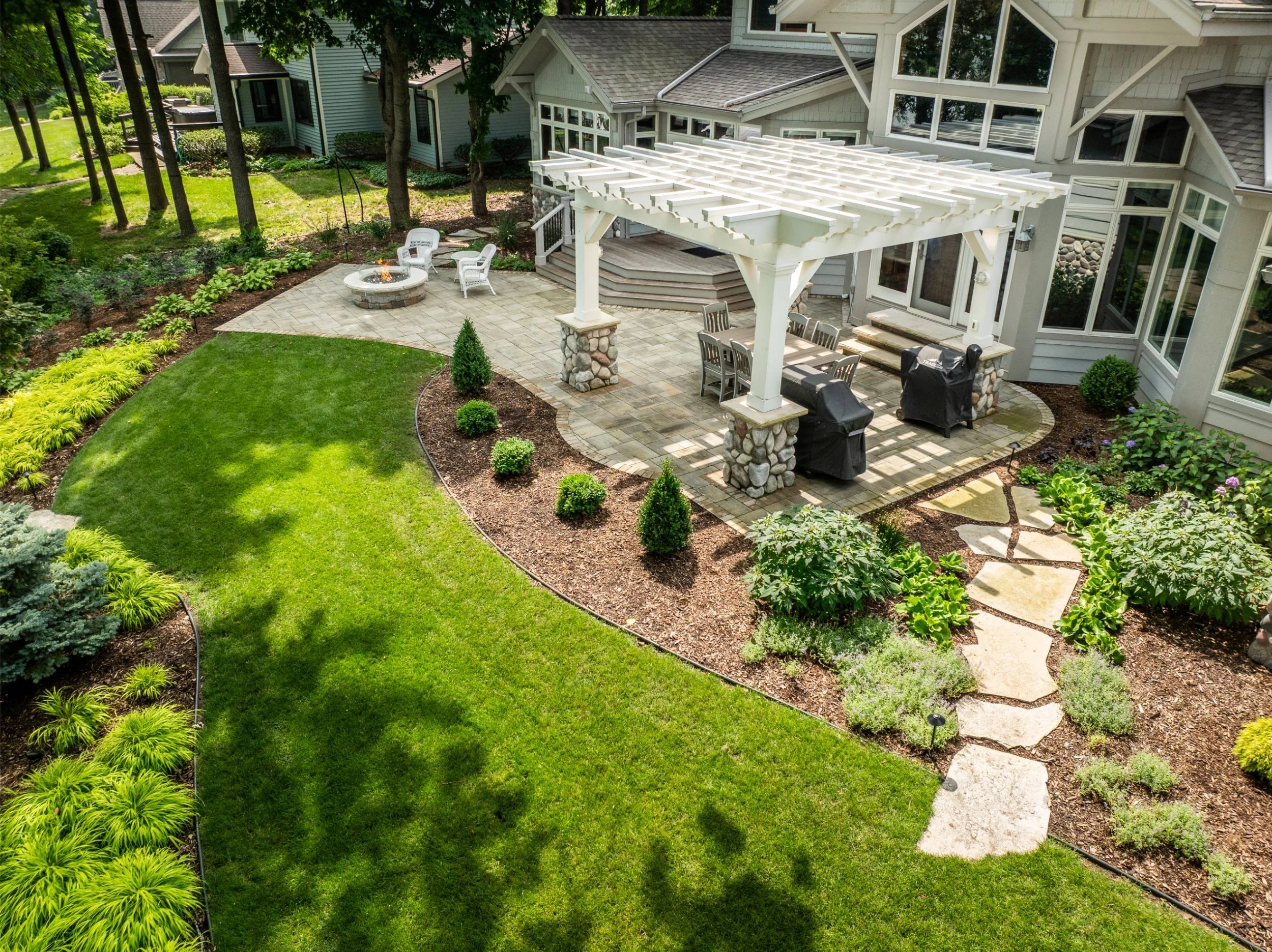 A meandering flagstone walkway leading to a fire pit in Neenah, WI