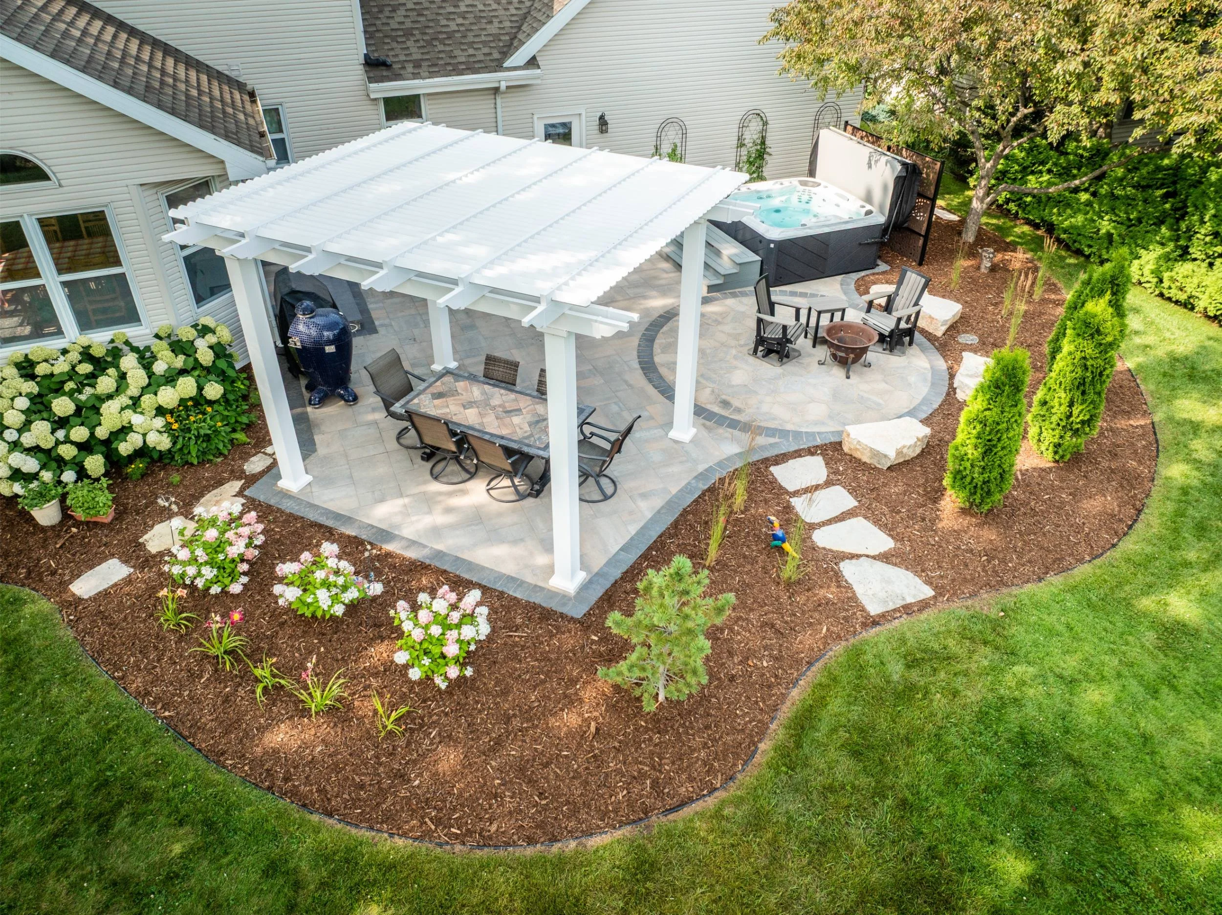 A family gathering zone accented with outdoor lighting in the Fox Cities, WI