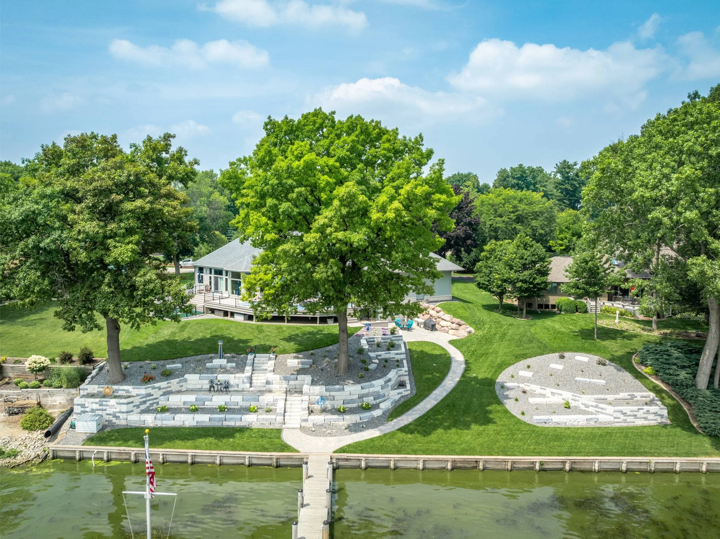 A cozy fire pit nestled into a lakeside setting in Neenah, WI