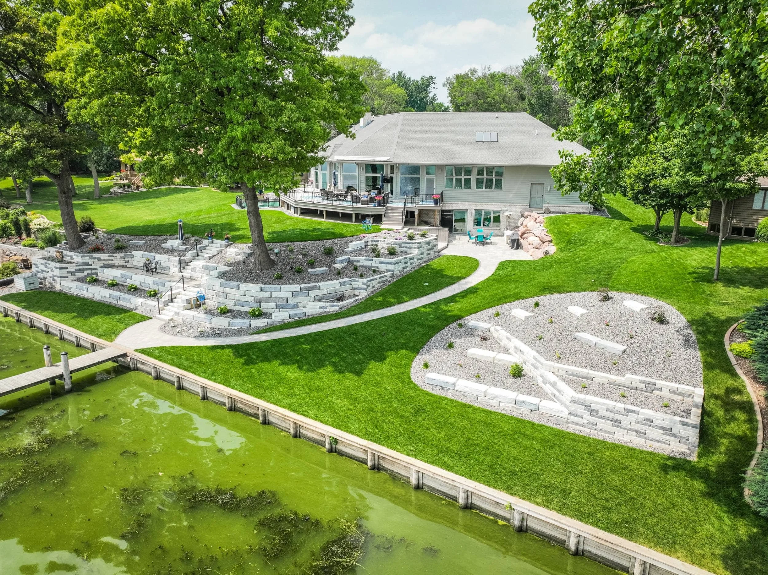 A custom lakeside retaining wall enhanced with outdoor lighting in Green Bay, WI