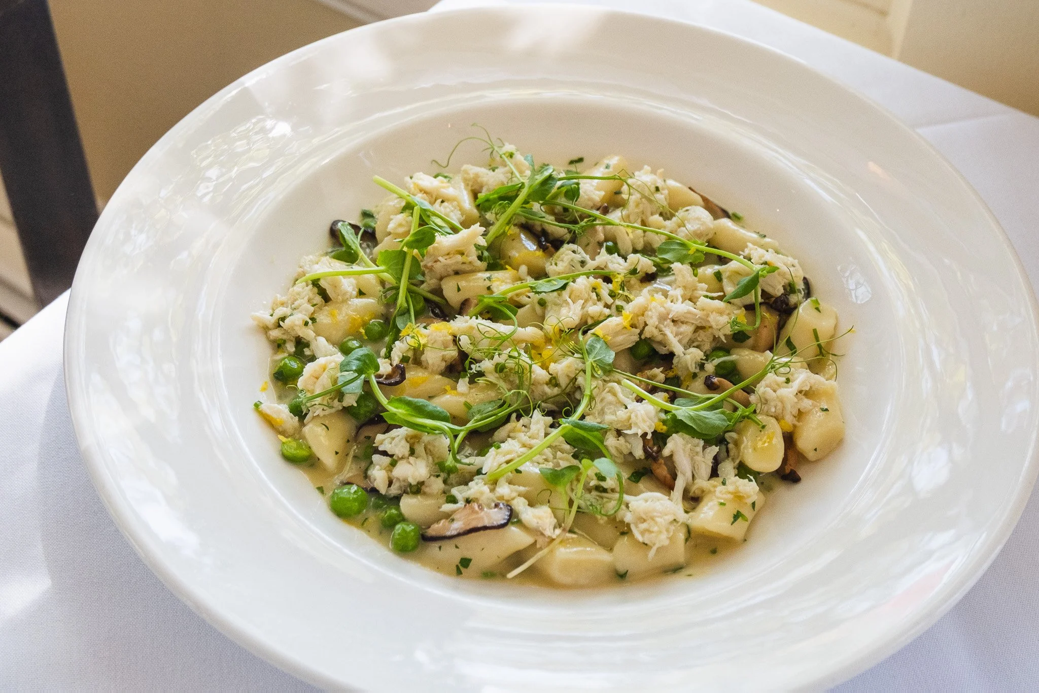 Spring along the coast, beautifully composed.

Our Parmesan gnocchi is a celebration of the season&mdash;pillowy bites folded with delicate blue crab, earthy shiitake mushrooms, and sweet peas, all brightened with fresh lemon zest. 

On special this 