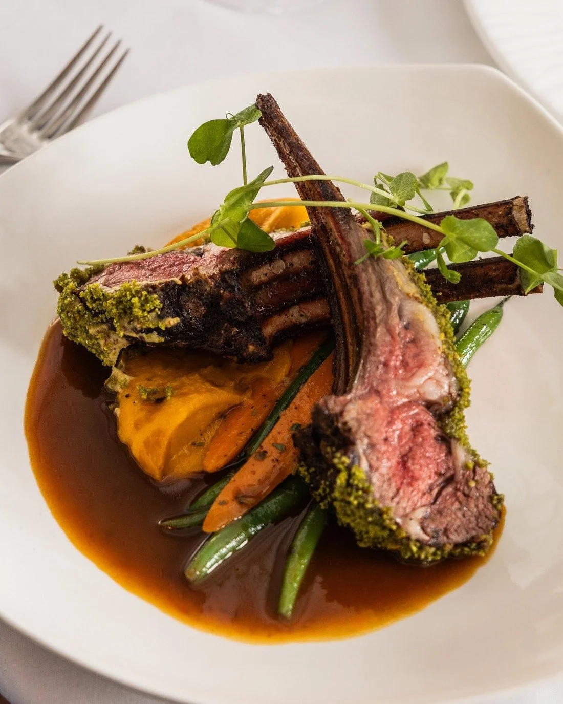 A guest favorite for good reason, our Australian Rack of Lamb is the perfect way to celebrate the season. Perfectly cooked and finished with a savory pistachio crust, the lamb is paired with ginger-glazed seasonal vegetables, silky yam pur&eacute;e, 