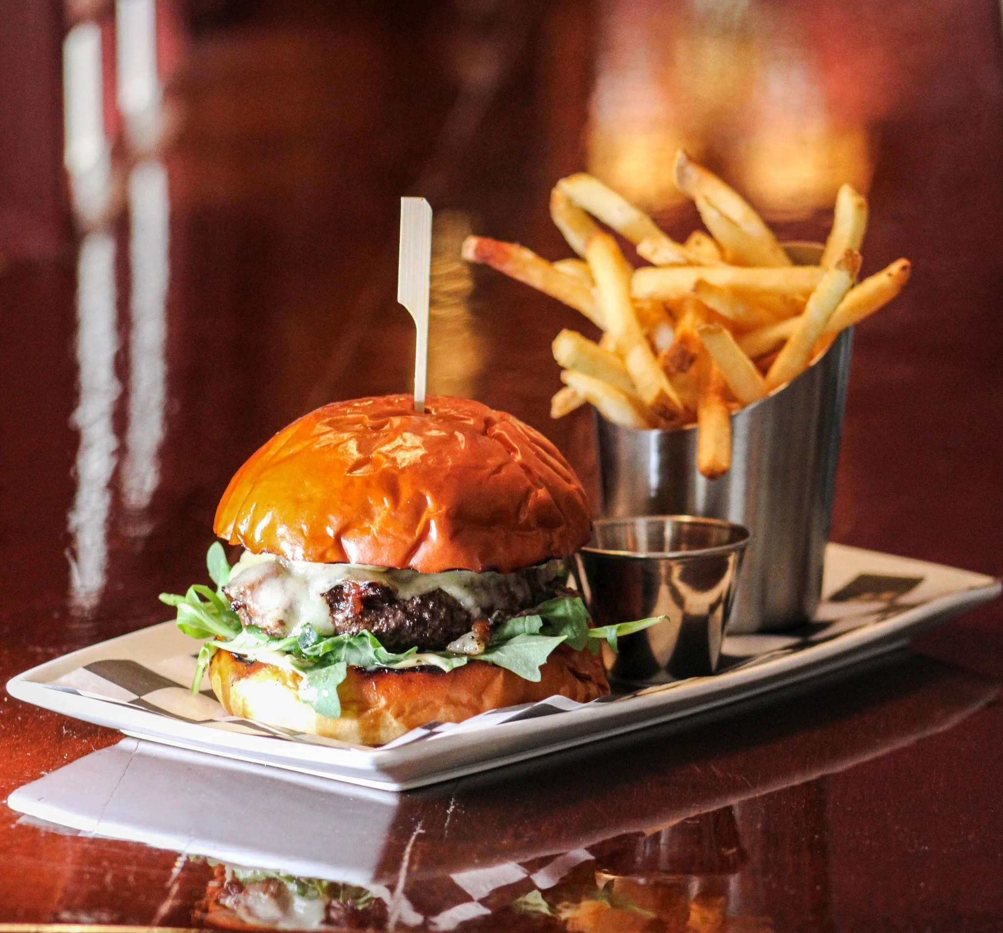 Join us tonight at the Wine Bar for one of our guest favorites: the Jefferson Burger. Crafted with melted fontina, bacon &amp; onion jam, fresh arugula, roasted garlic aioli, and served alongside crispy French fries, it's the perfect excuse to pull u