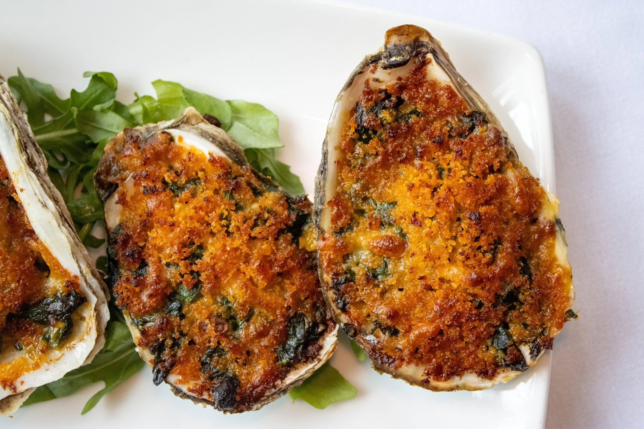 Baked to golden perfection with spinach, bacon, parmesan and smoked paprika. Our Oyster Rockefeller has been a favorite for as long as we can remember, and it's easy to see (and taste) why.

#capemay #finedining #seafood #washingtoninn