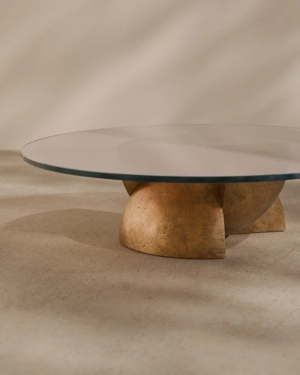 The Axis Coffee Table.
A meditation on balance, contrast and coexistence. Four intersecting forms supporting a single glass plane. Inspired by the idea of superposition, where opposing states don&rsquo;t cancel out but exist together in harmony.

Num