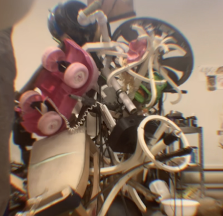 A pile of assorted children's ride-on toys stacked together.