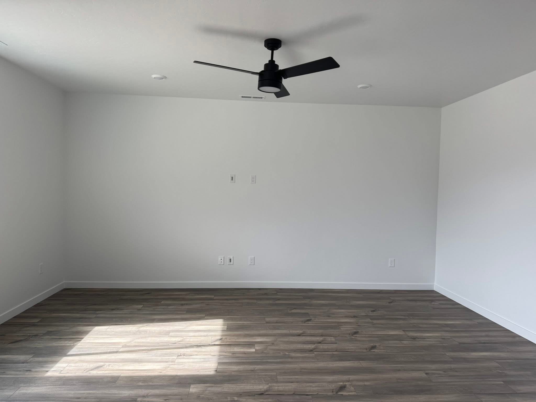 Before photo of a blank living room wall prior to installing a custom stone fireplace and built-in entertainment center in Caldwell, Idaho.