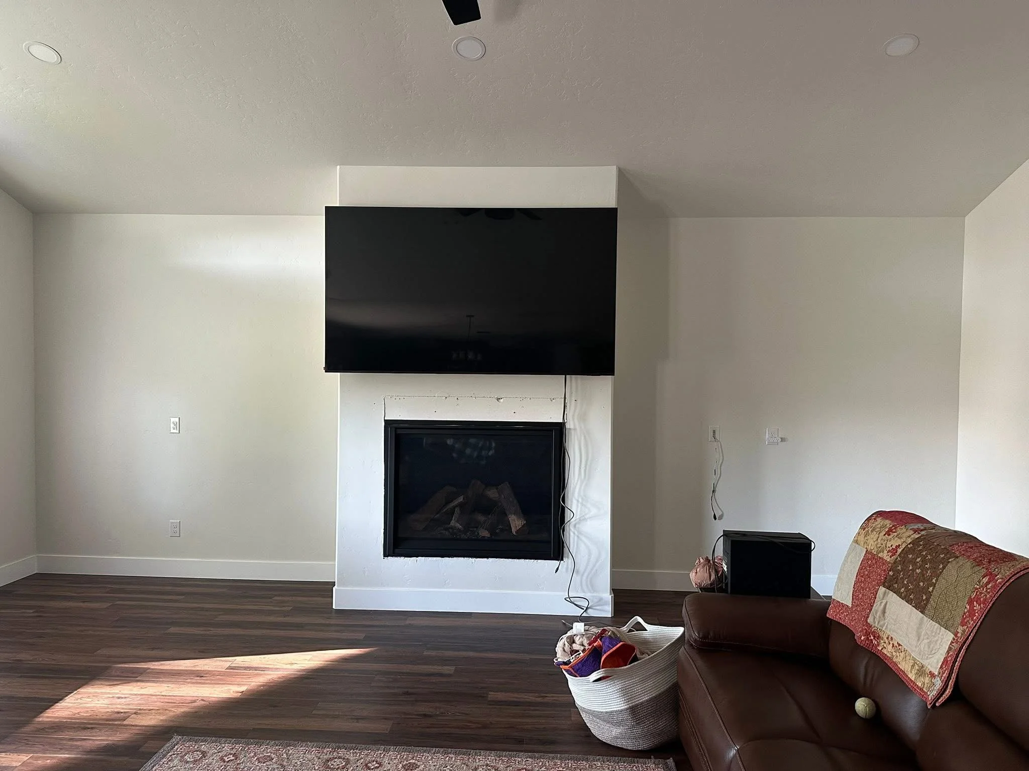 Before photo of a fireplace wall prior to installing custom built-in cabinets and shelving in Wilder, Idaho.