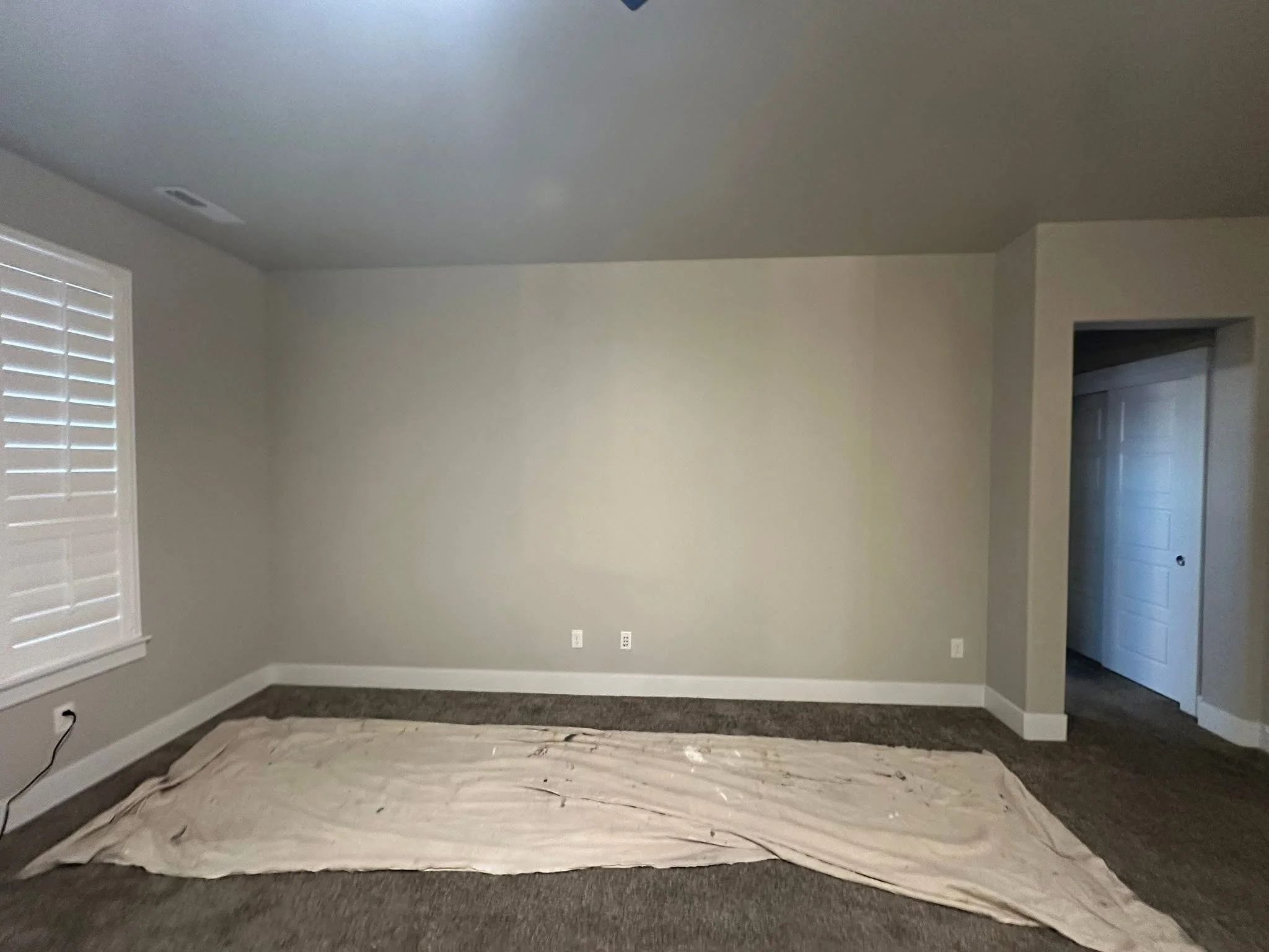 Before photo of a blank living room wall before installation of custom built-ins and an electric fireplace feature wall in Meridian, Idaho.