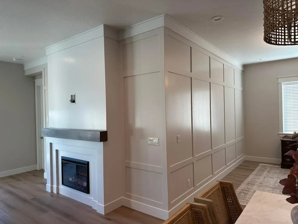 Custom fireplace with a floating wood mantel and full-height board and batten feature wall in a Meridian, Idaho home.