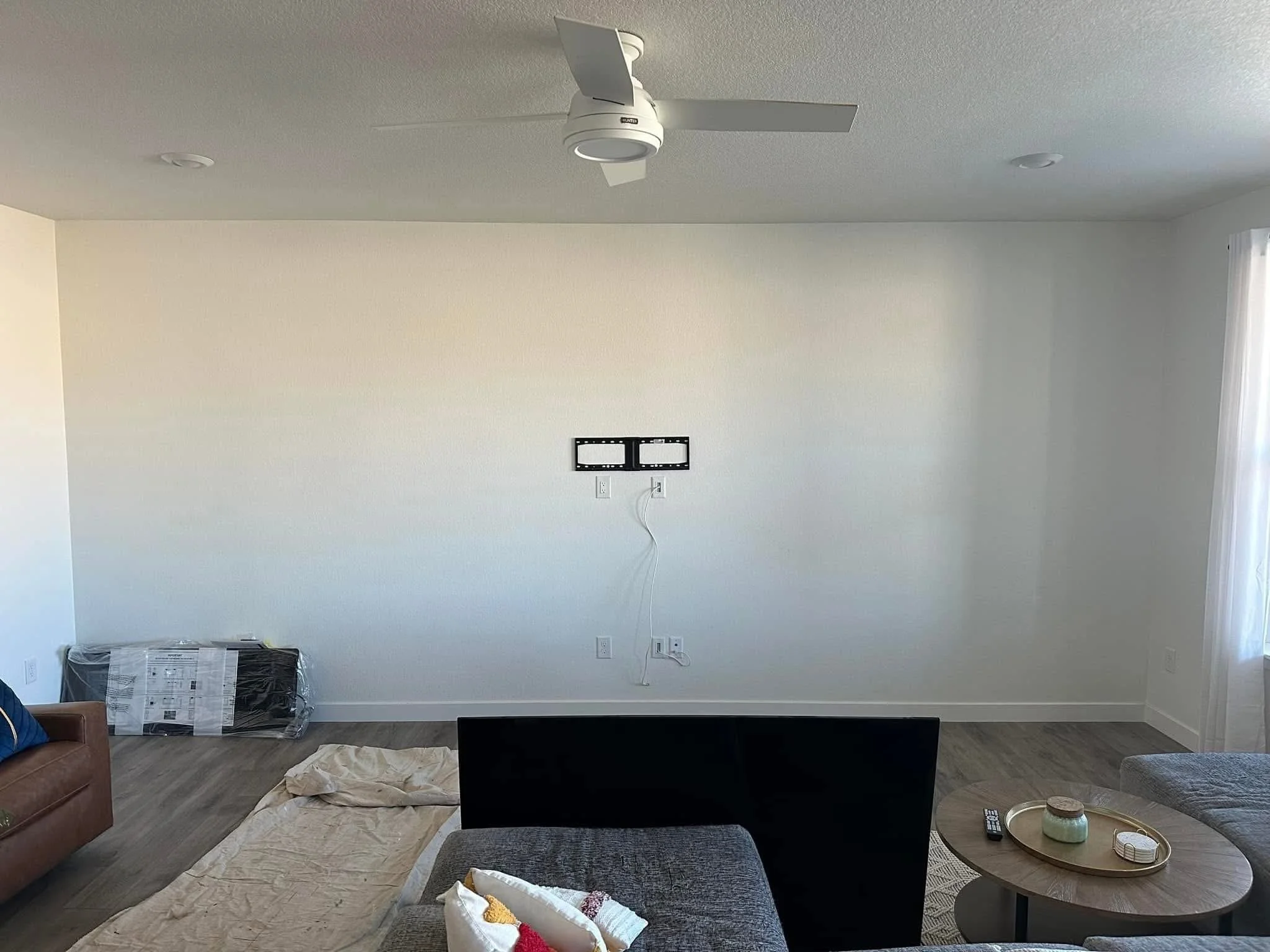 Before photo of a living room wall prior to installing custom fireplace built-ins and a shiplap entertainment center in Caldwell, Idaho.