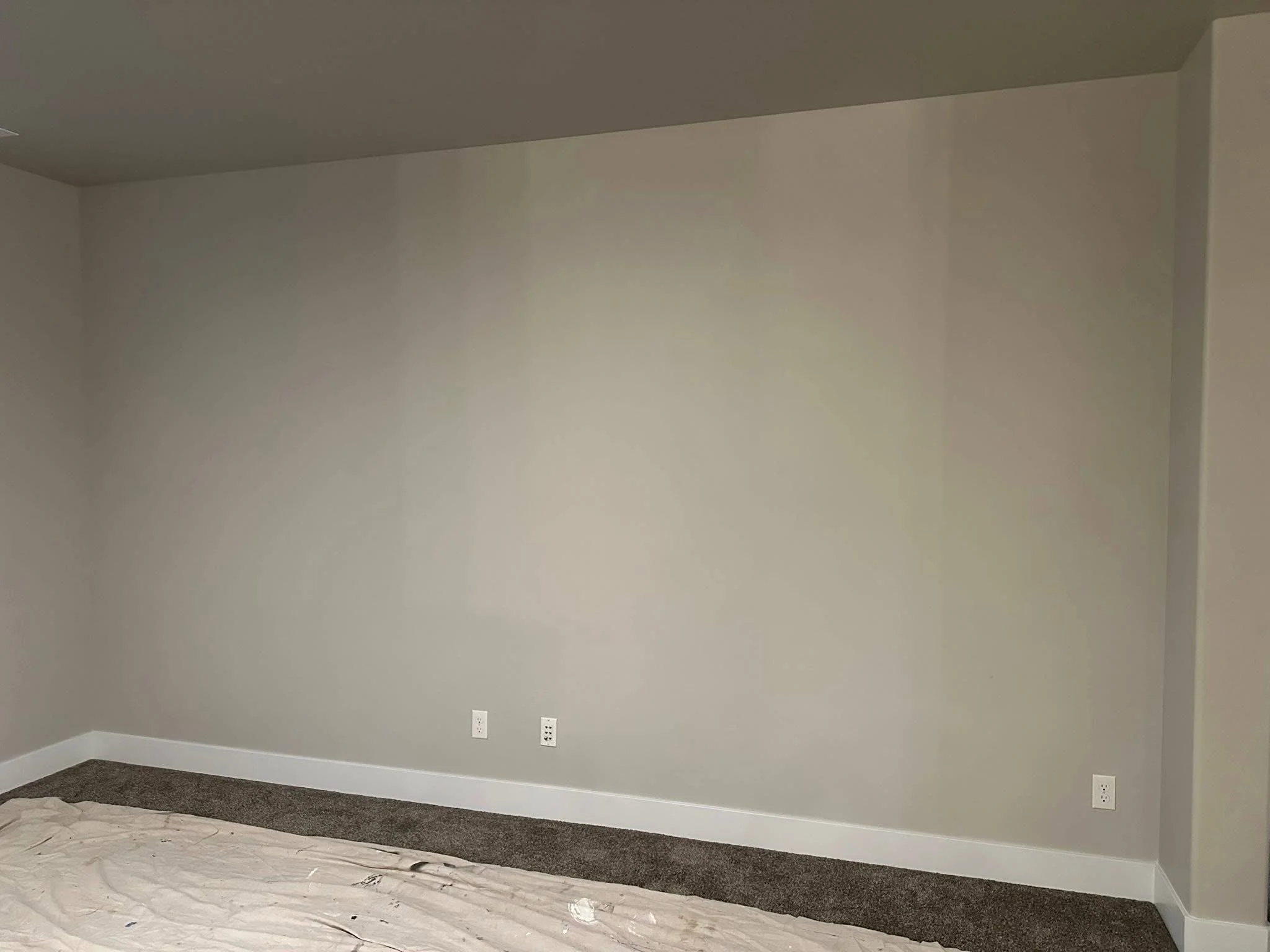 Before photo of a living room before adding a custom entertainment center, fireplace surround, and built-in shelving in Meridian, Idaho.