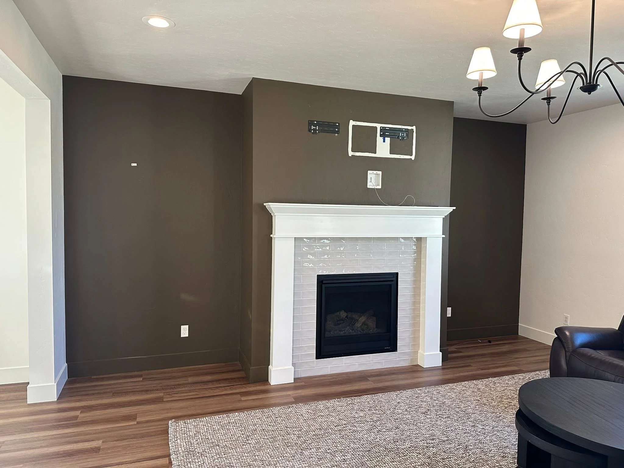 Living room before custom built-in bookshelves and cabinetry were added around the fireplace in Star, Idaho.