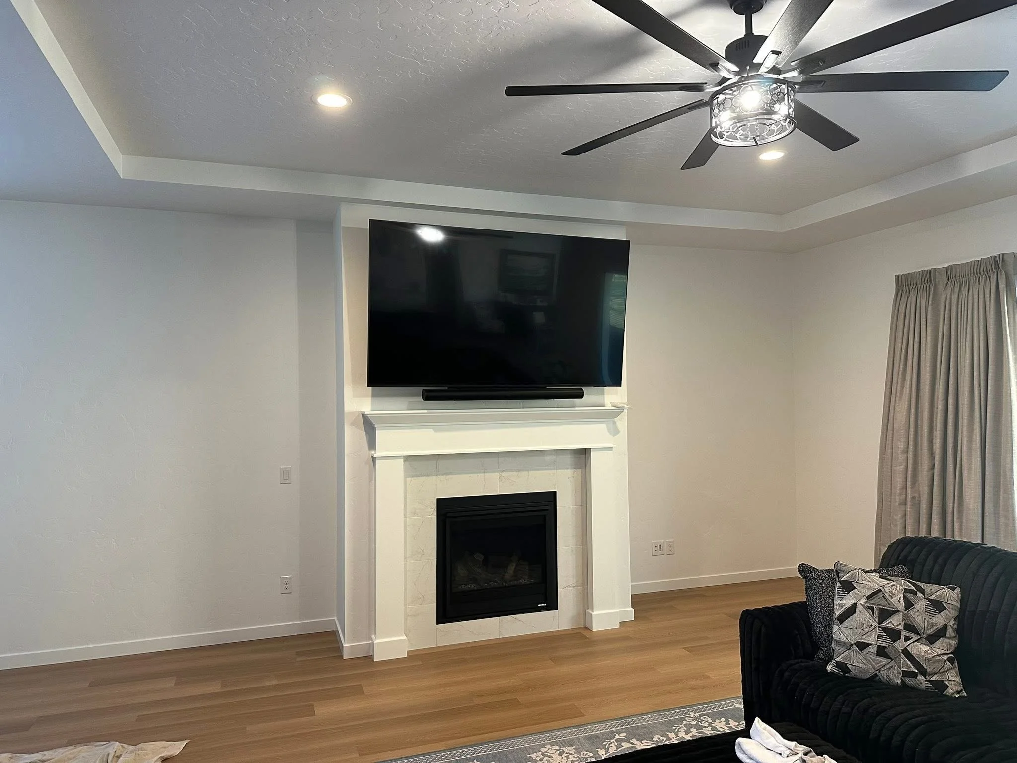 Before photo of a living room wall prior to installing custom built-in shelving and a fireplace entertainment center in Star, Idaho.