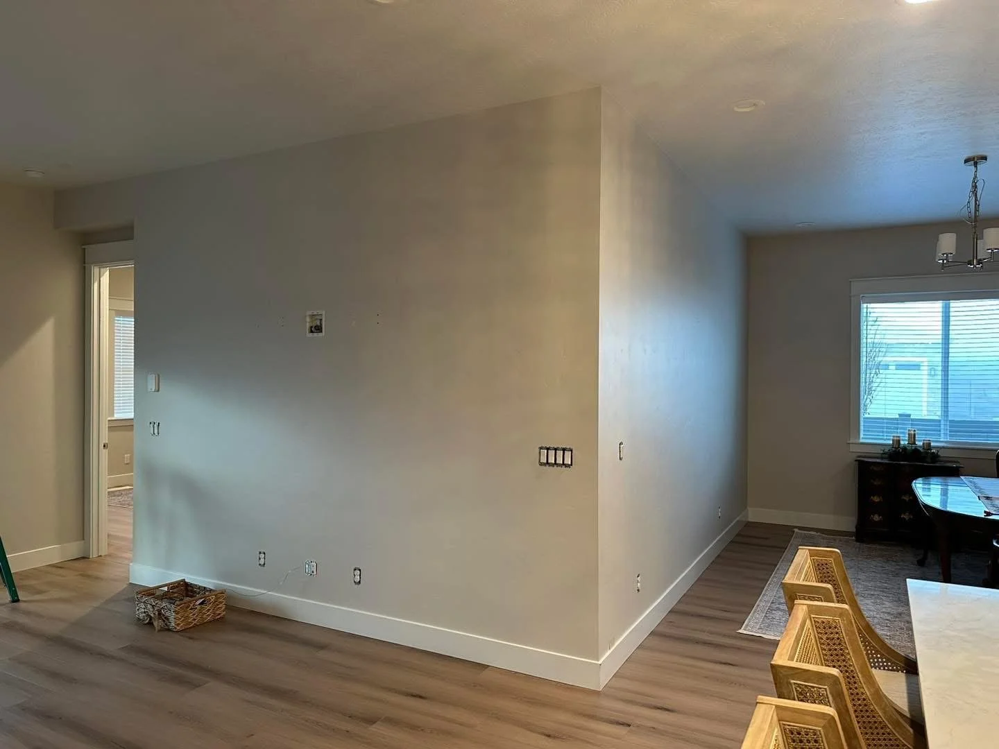 Before photo of a blank fireplace wall prior to installation of custom trim, board and batten, and a floating wood mantel in Meridian, Idaho.