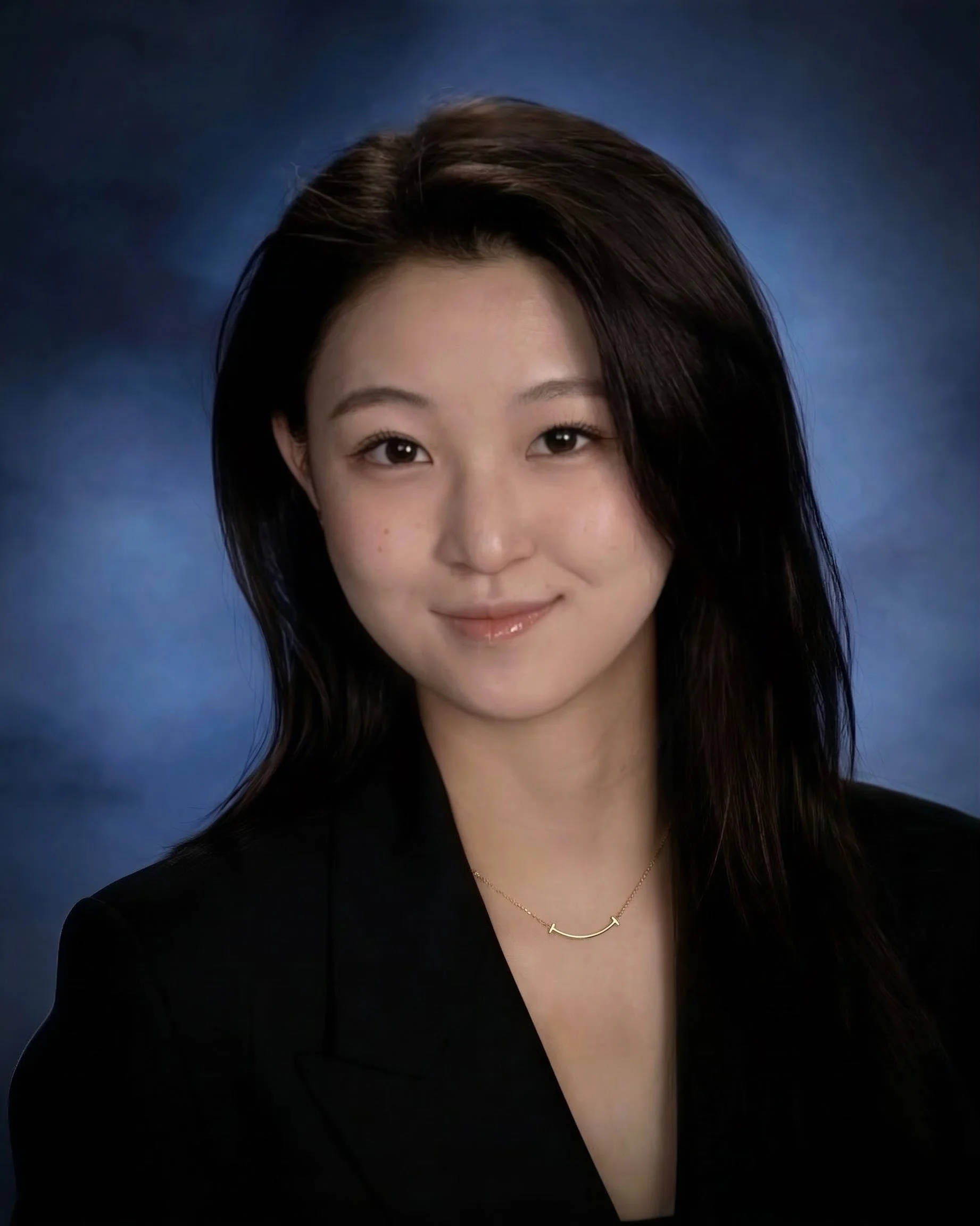 Woman with long blonde hair smiling at the beach.