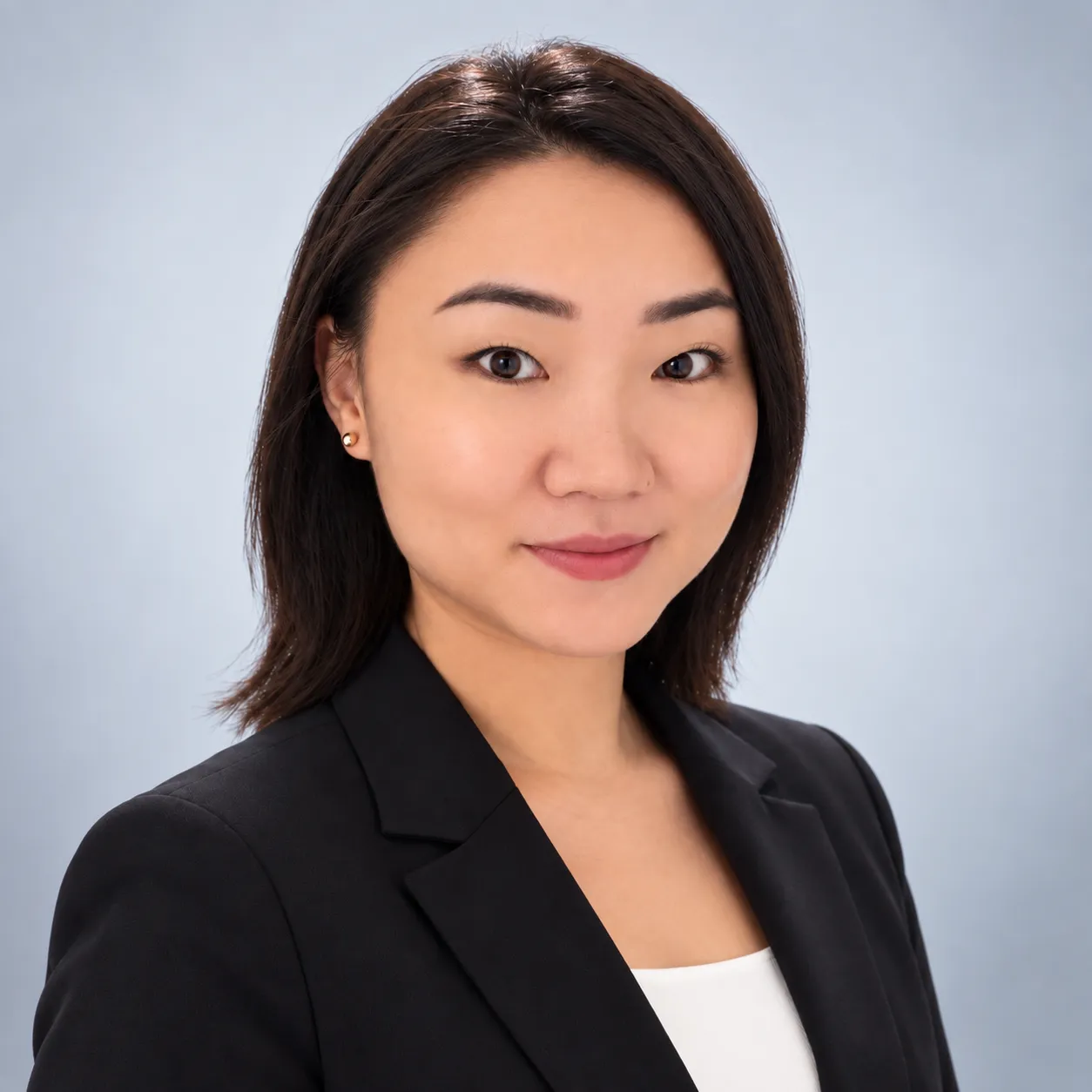 Woman in a business suit smiling in front of a white background with black business-themed illustrations.