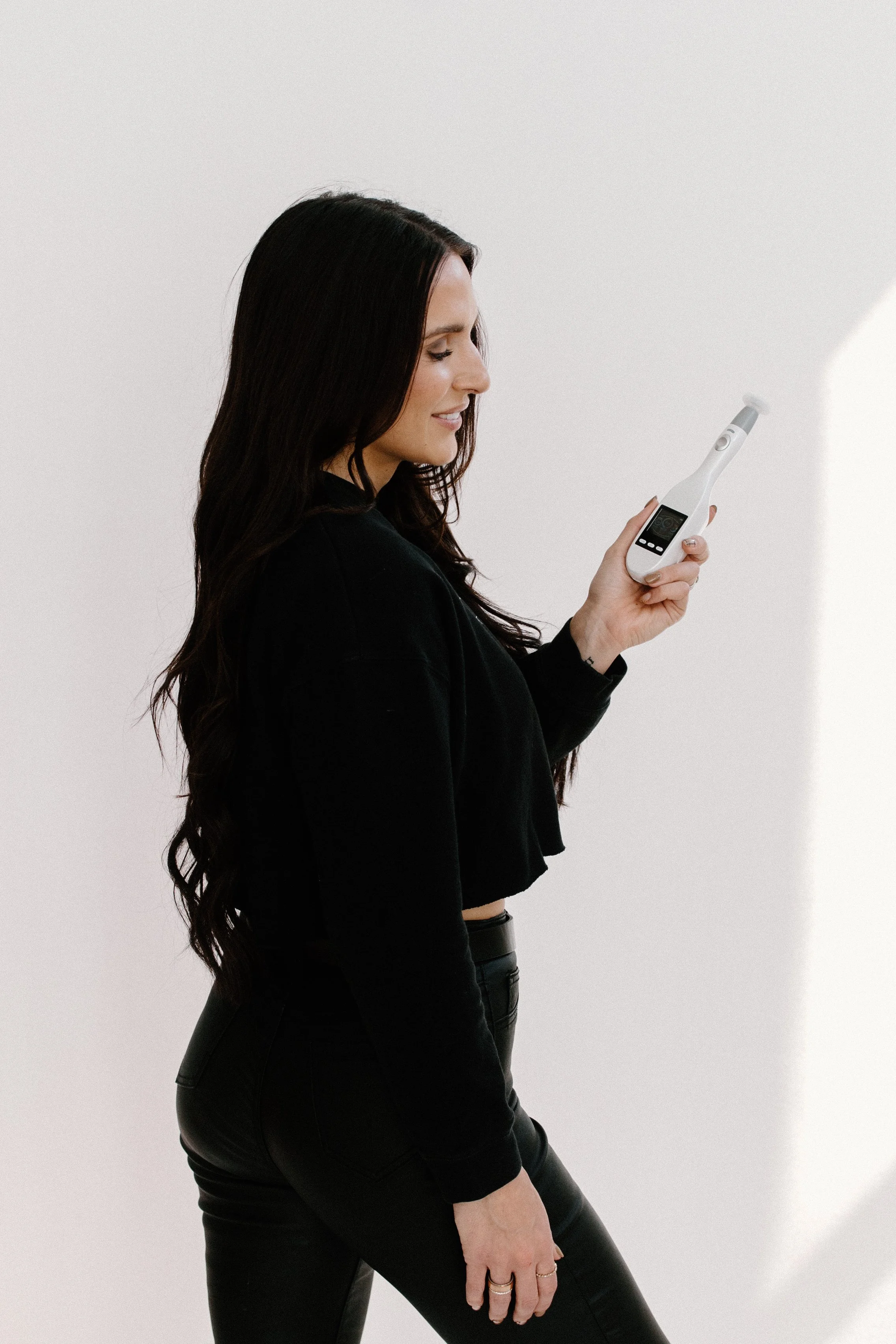 Licensed Esthetician and Owner of Allure Aesthetics and Beauty Co. in Oregon, Illinois, holding a Jet Plasma tool for clients looking for corrective skincare and facial treatments.