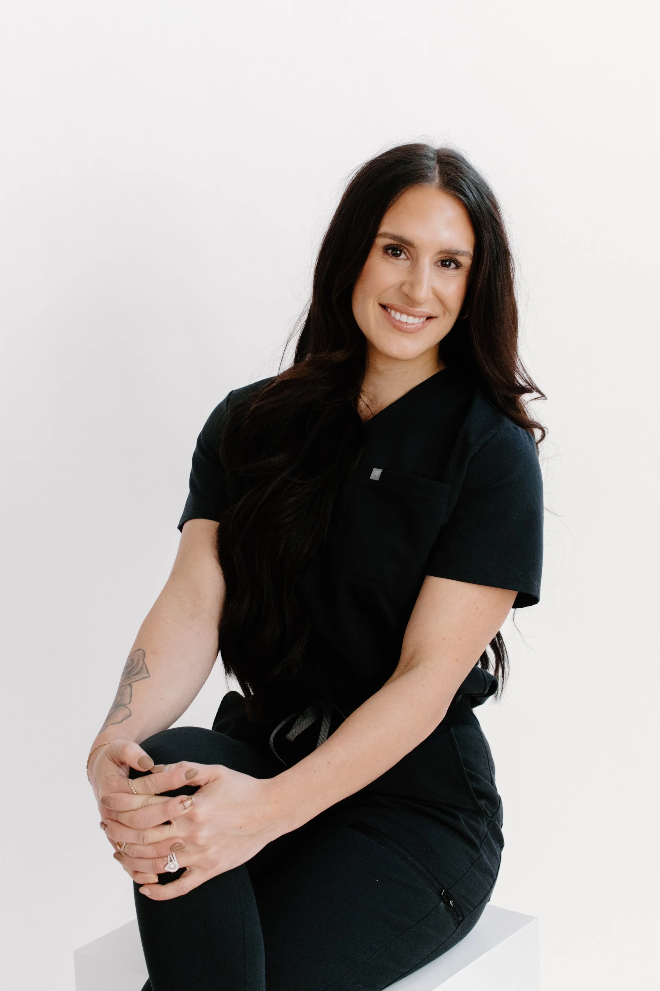 Licensed Esthetician and Owner of Allure Aesthetics and Beauty Co. in Oregon, Illinois, holding a Microchanneling (similar to Microneedling) tool for clients looking for corrective skincare and facial treatments.