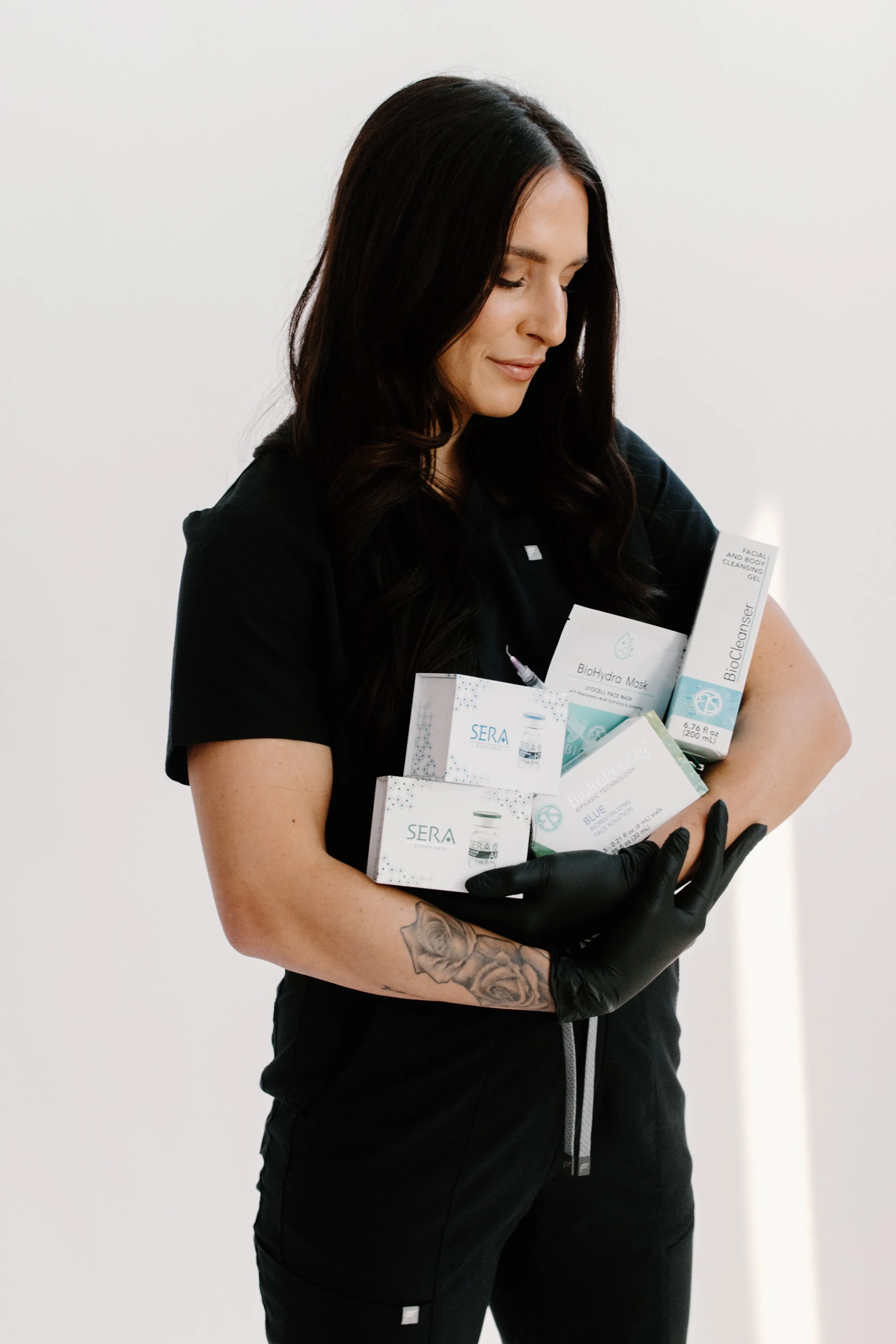 Licensed Esthetician and Owner of Allure Aesthetics and Beauty Co. in Oregon, Illinois, providing a facial treatment for a client looking for corrective skincare and facial services.